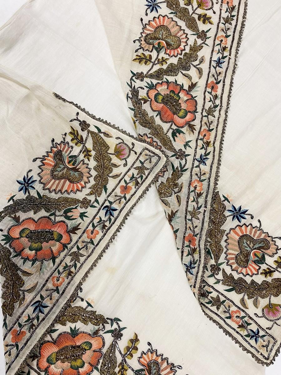 Late 18th or early 19th century
Ottoman Empire

Superb Hammam scarf/ stole in ecru cotton veil densely embroidered at each end. Reversible embroidery (like the most beautiful Ottoman embroidery) decorated with stylized flowers (pomegranates?) Finely