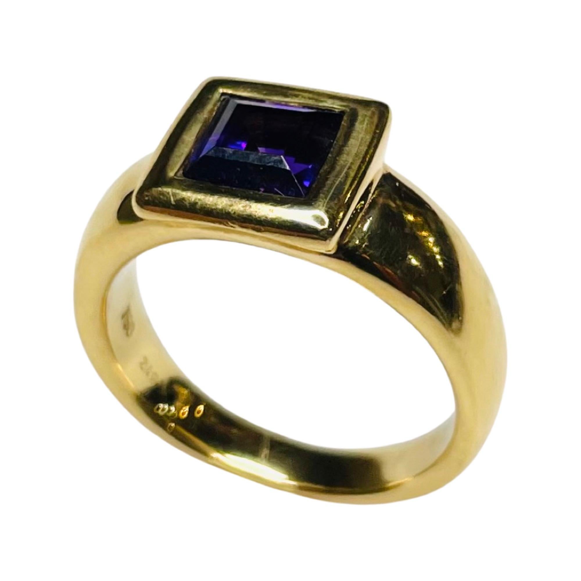Hammer & Sohne 18k Yellow Gold Ring with Square Cut Faceted Amethyst. It is finger size 7.  It can be sized for an additional fee. The bezel is 9.25 mm. The shank is 6.0 mm at the top and tapers to 3.5 mm at the base of the shank. 100-70-51