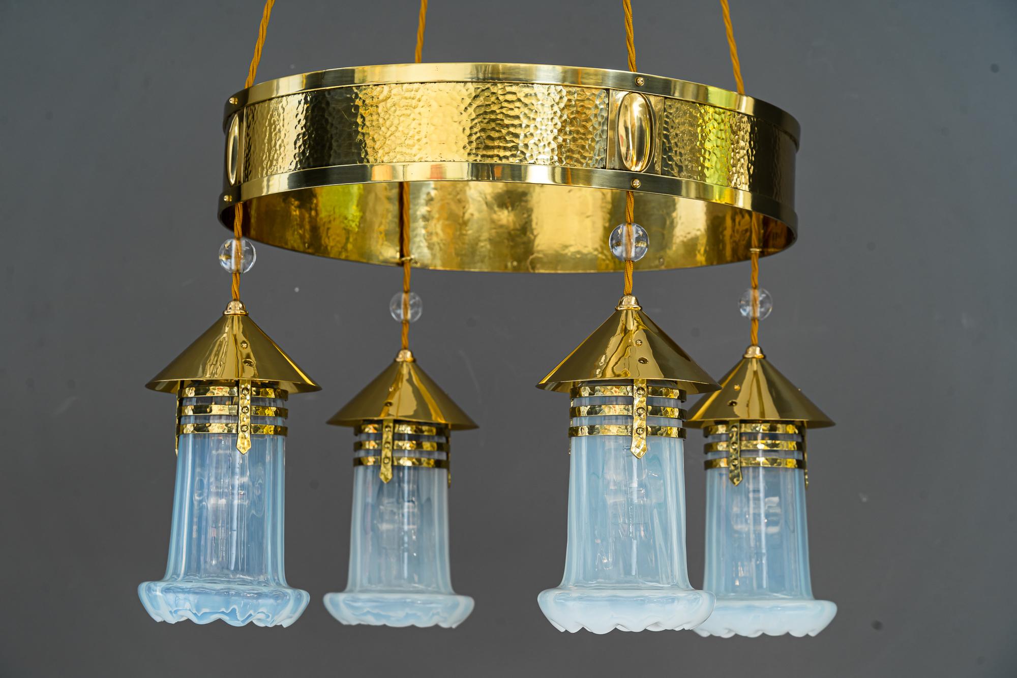 Hammered Art Deco Chandelier with opaline glass shades, Vienna, around 1920.
Polished and stove enameled.
Original old opaline glass shades.
 