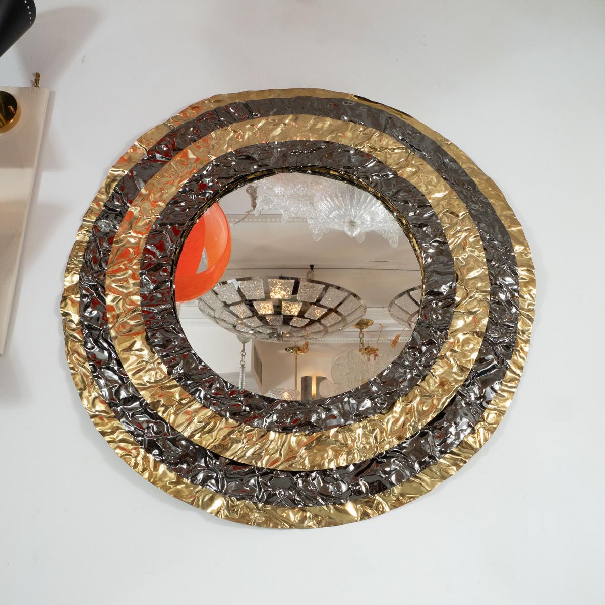 Layered, hammered brass mirror with bullseye design.