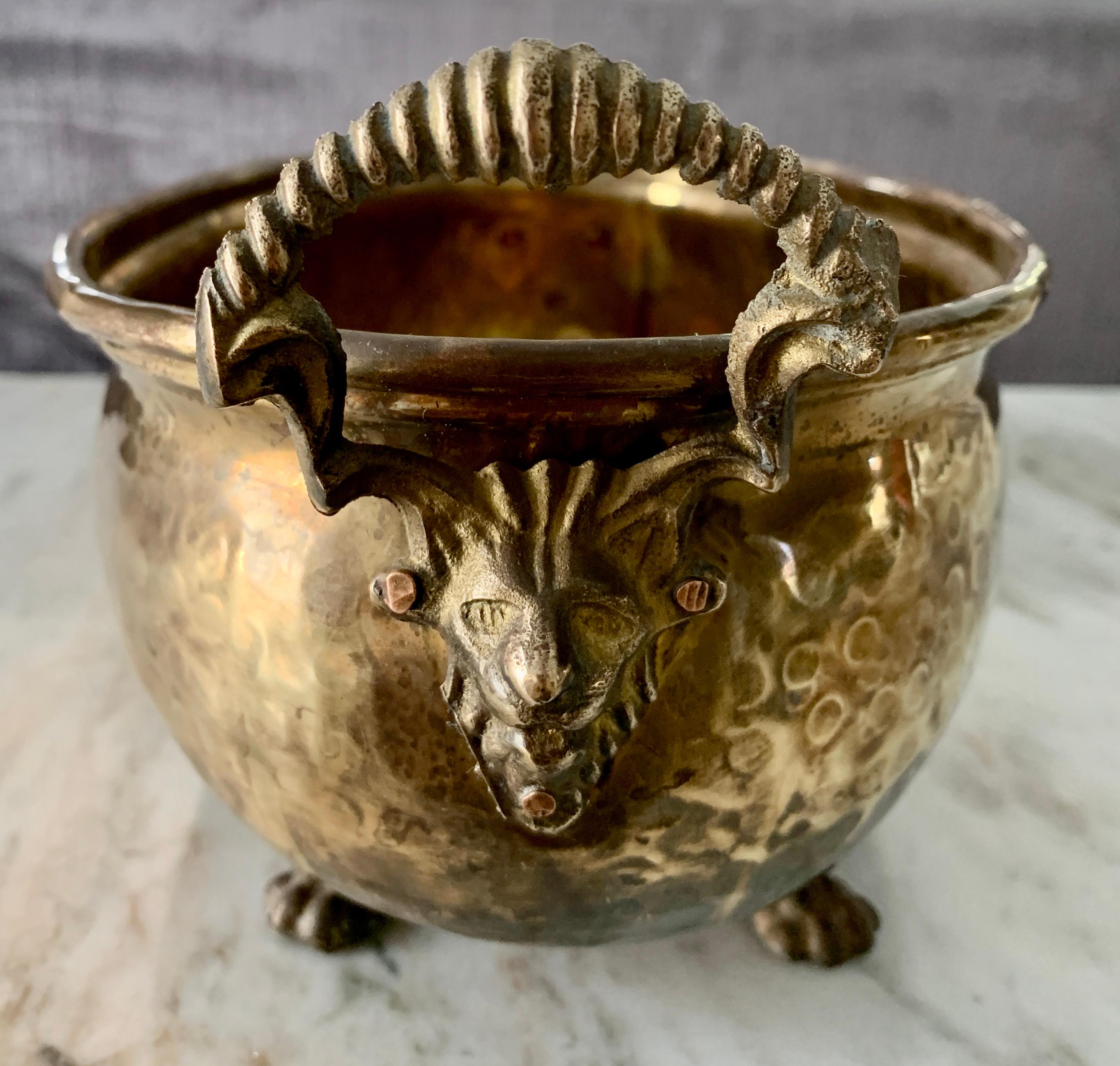 Oval brass hammered jardinière with paw feet, the lion handles are a great touch - a great oval shape and size for center piece, kitchen island - or as a planter, catch-all or for the desk... A wide range of uses and in a stunning piece!