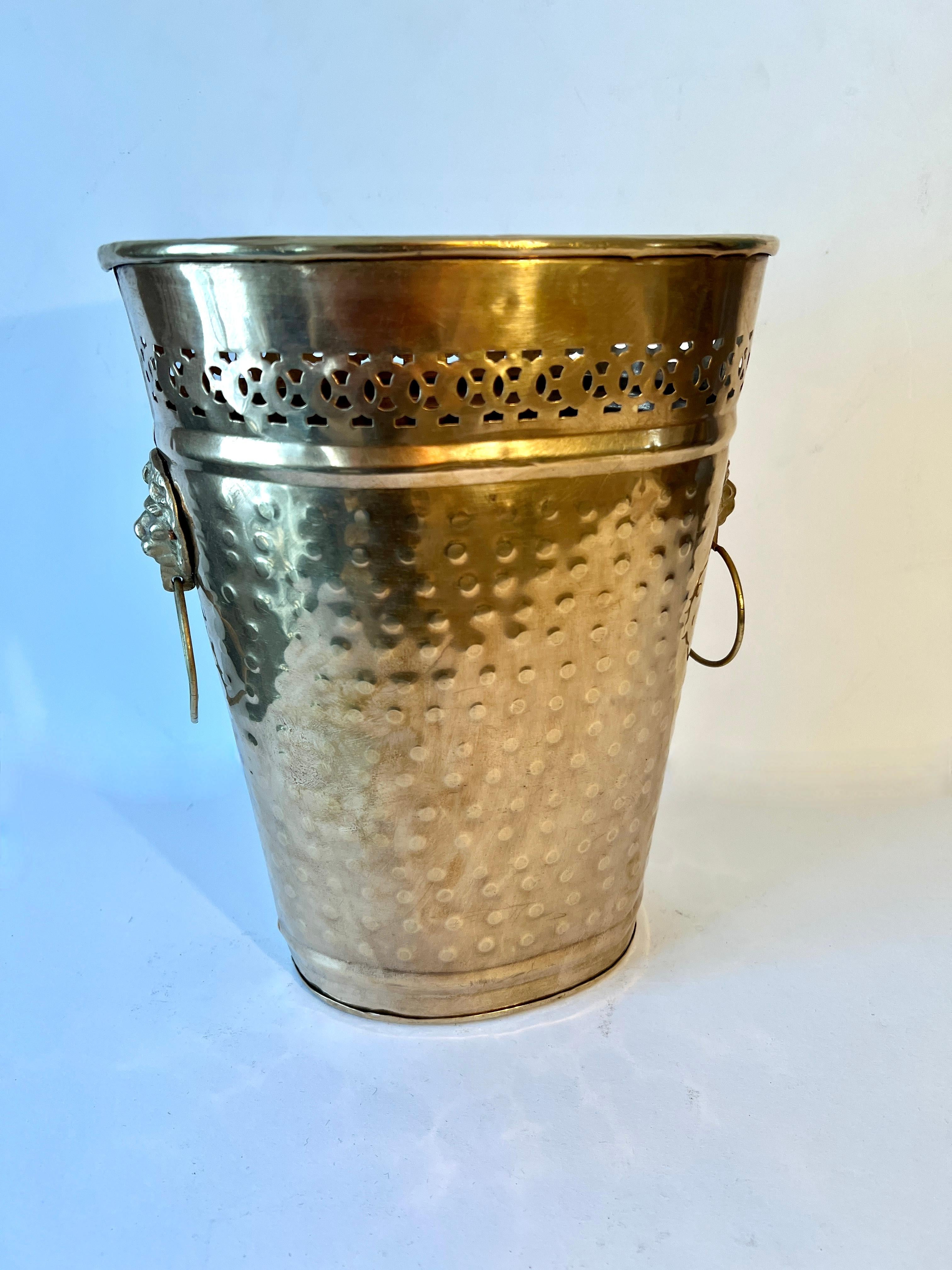 A beautiful oval Hammered Brass Trash Can / Bin with Lions heads with a ring on each side.  

A complement to any commercial or home office, in the work room, kitchen, guest room or bathroom.

Please note that the platform’s price guidance tool may