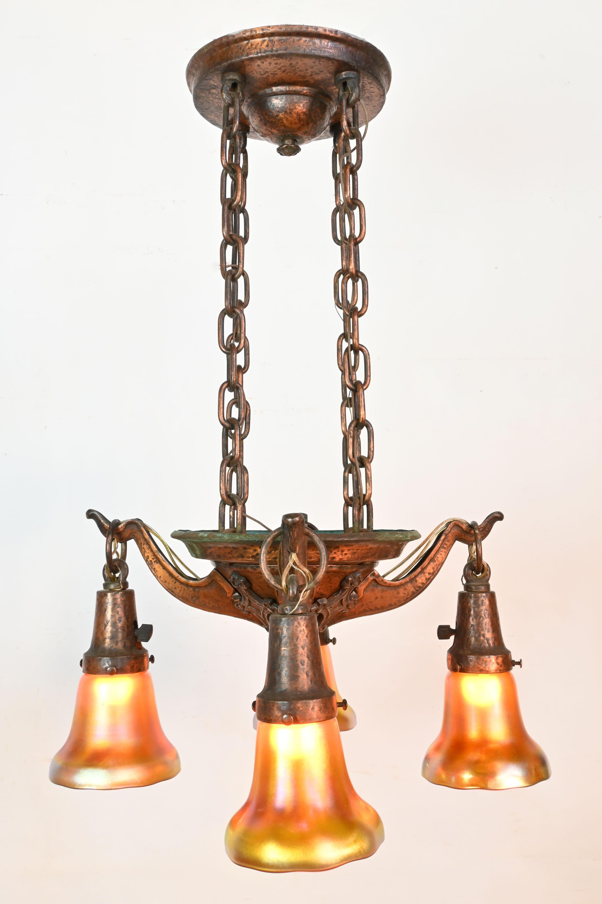 Stupendous detail in this 4 arm chandelier, the large amount of copper in the bronze has given rise to a unique patina. The length of the chandelier adds to its grandiose feel but nothing shows the artistry in this light like the coloring of the