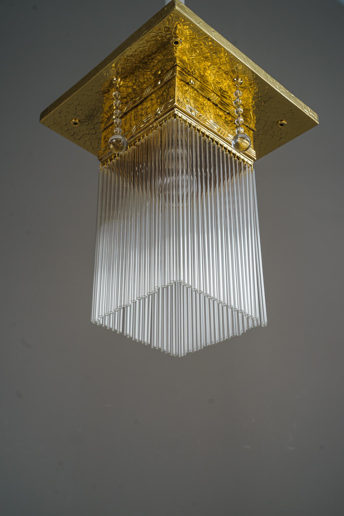 Hammered ceiling lamp with glass sticks vienna around 1920 
Brass polished and stove enameled
Glass sticks are replaced ( new )