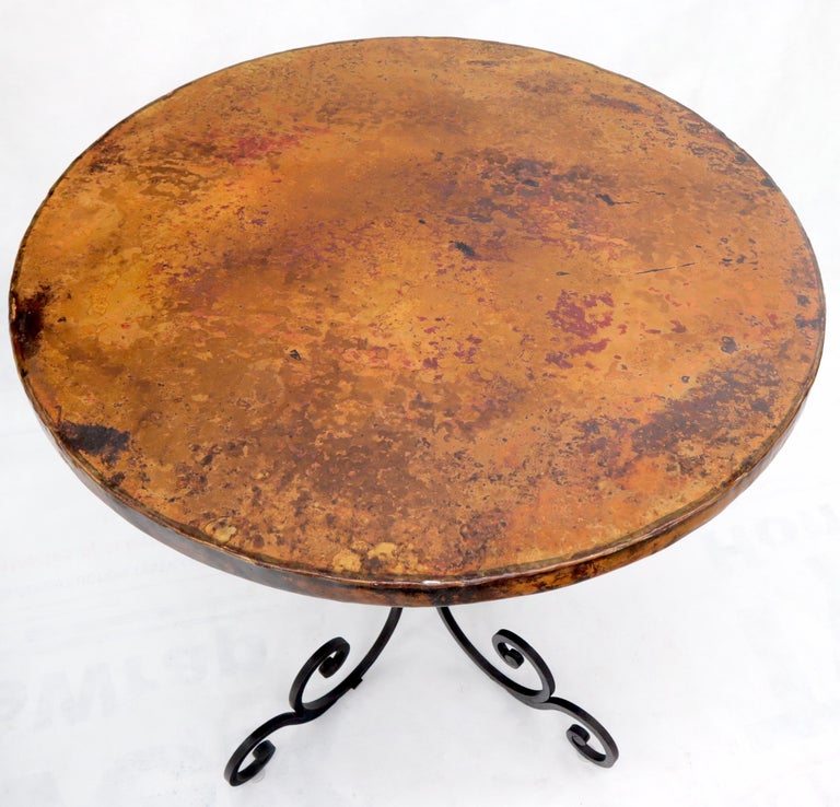 Decorative midcentury decor round cafe table with hammered coper top.