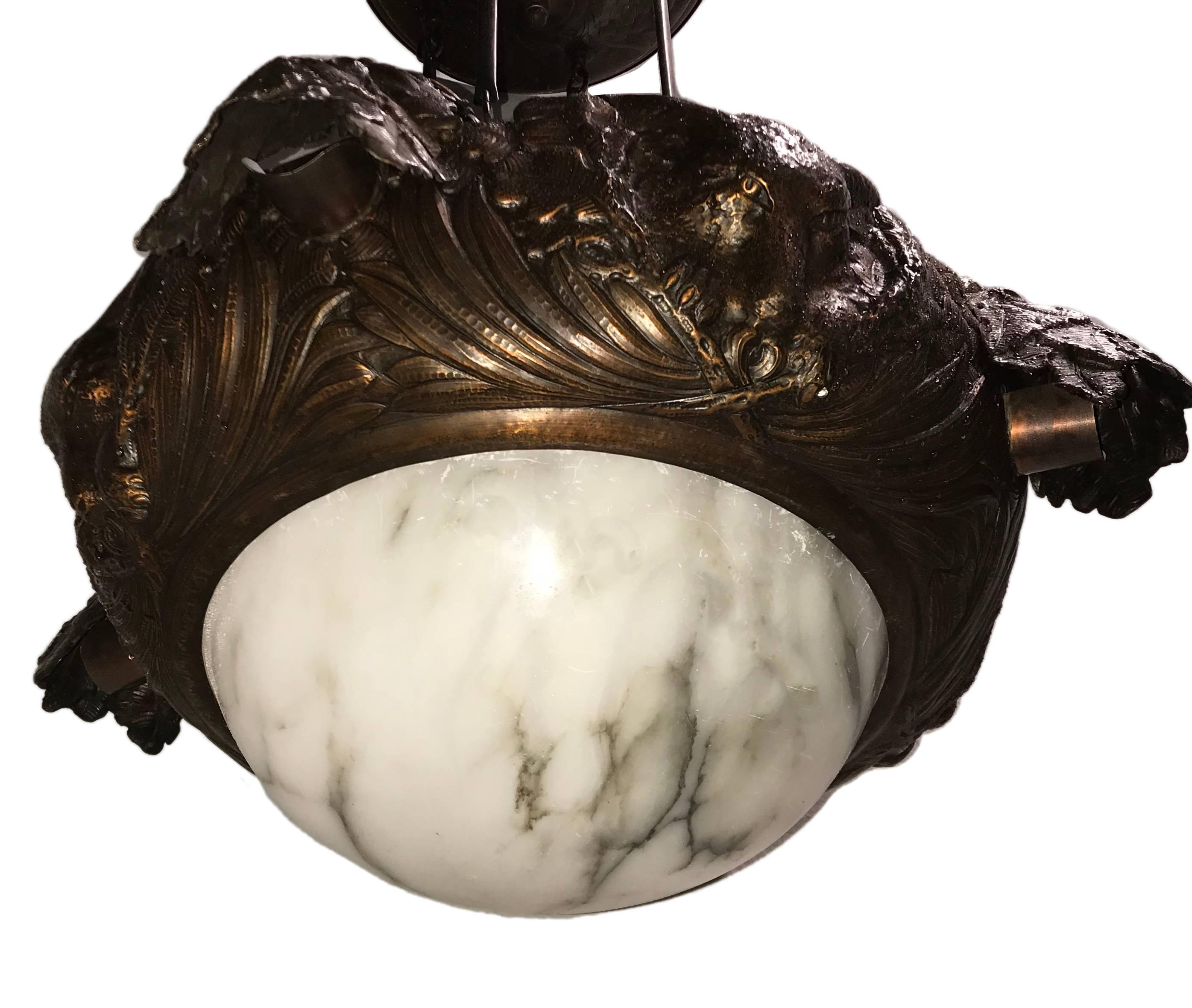 A English hammered copper light fixture with foxes and acorns details, and alabaster inset, circa 1920s.

Measurements:
Diameter 30