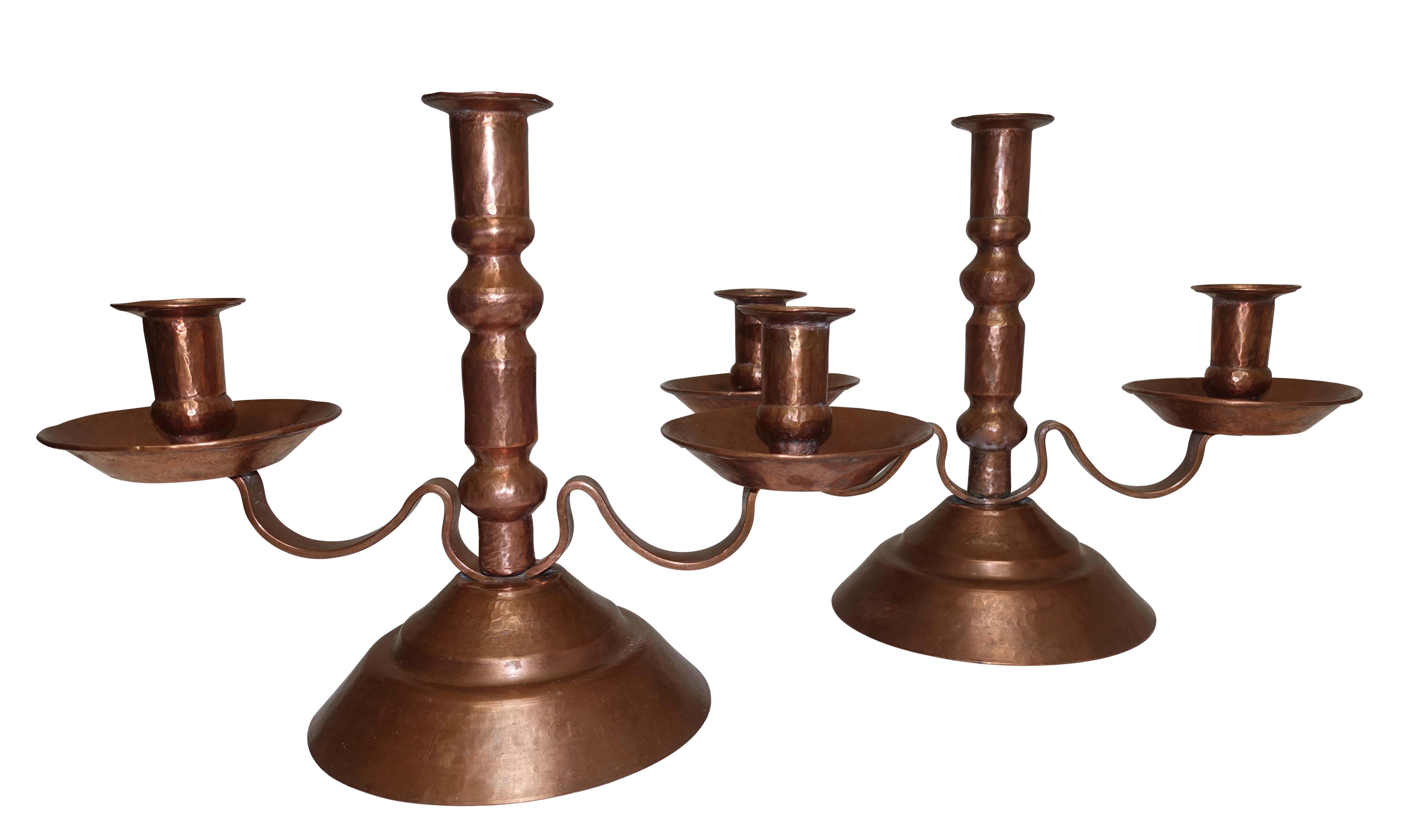 A pair of hand-hammered copper candleholders, Mexico, early to mid-20th century.