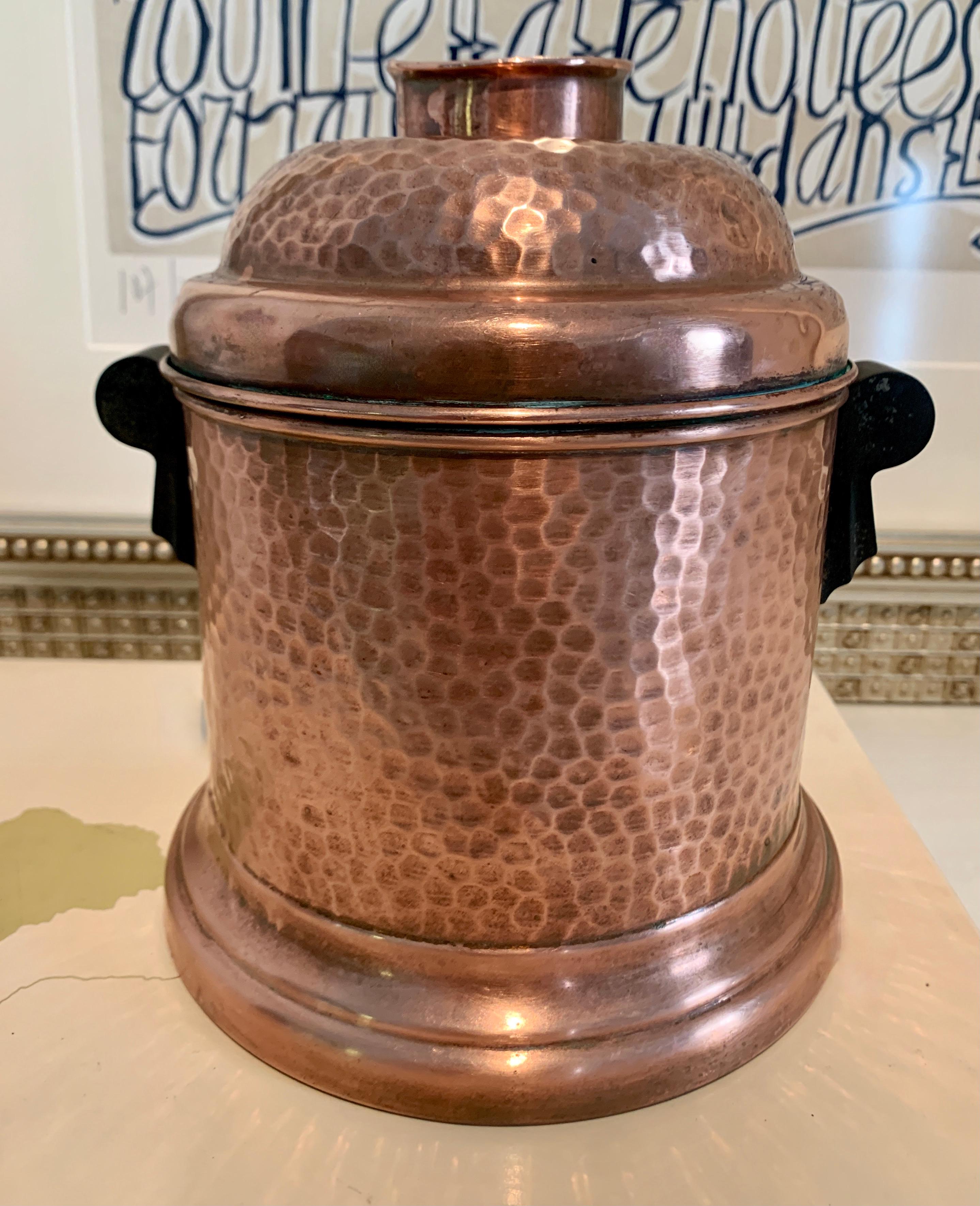 A large hammered copper Humidor with Removable lid and Bakelite Handles. The piece is large enough for your tobacco, cigars, or even use it as a desk accessory or for tea! The copper is hammered and has decorative Bakelite handles. The removable lid