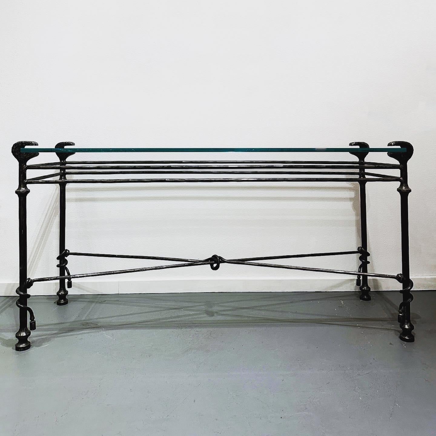 Glass and Iron Console Table in the Style of Diego Giacometti 

This is a gorgeous console table, in the style of Diego Giacometti, made of hammered and patinated iron with a thick glass top. This table would work with Modern interiors as well as