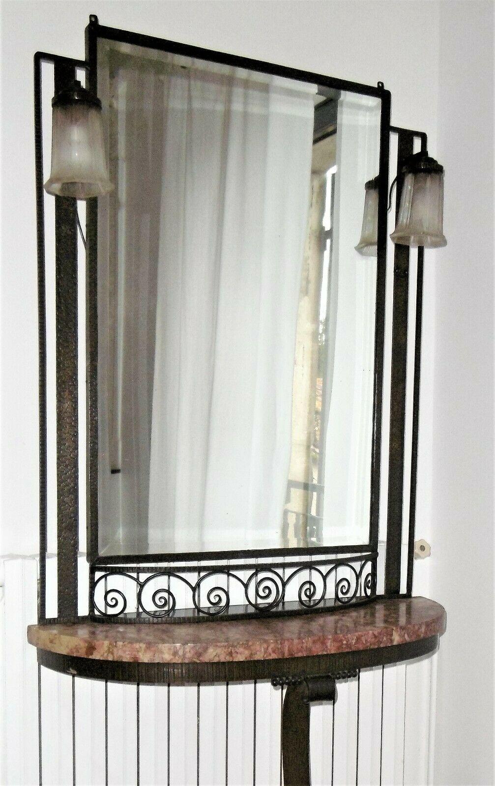 Hammered iron Art Deco Mirror and console, circa 1930
Wrought iron structure, marble top and small black opaline at the base of the mirror:

The 2 tulips are signed Hettier & Vincent
small shards at the base of one of the two tulips

Hauteur