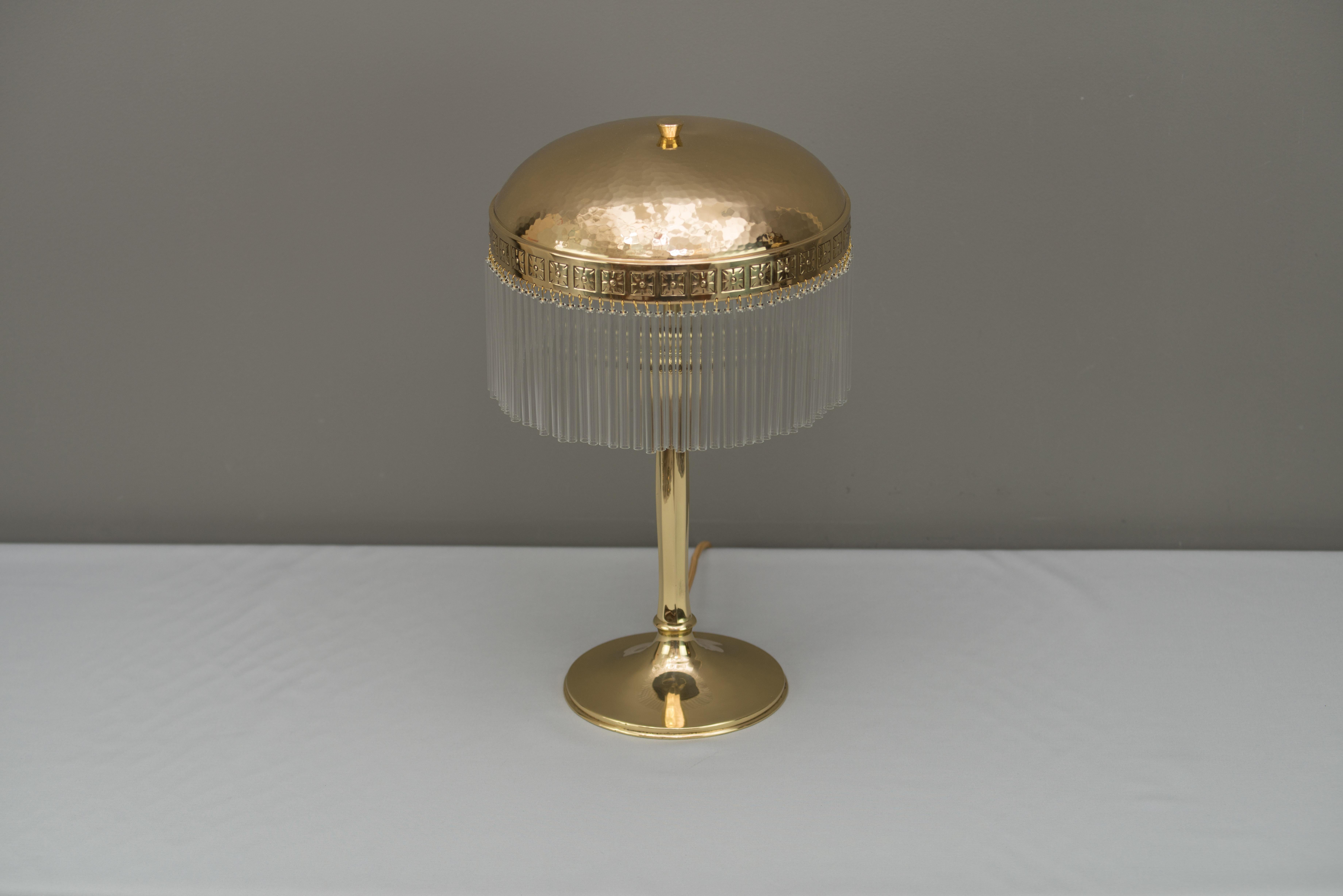 Hammered Jugendstil table lamp with glass sticks, circa 1910s
Polished and stove enameled
Glass sticks are replaced (new)
2 Bulbs.