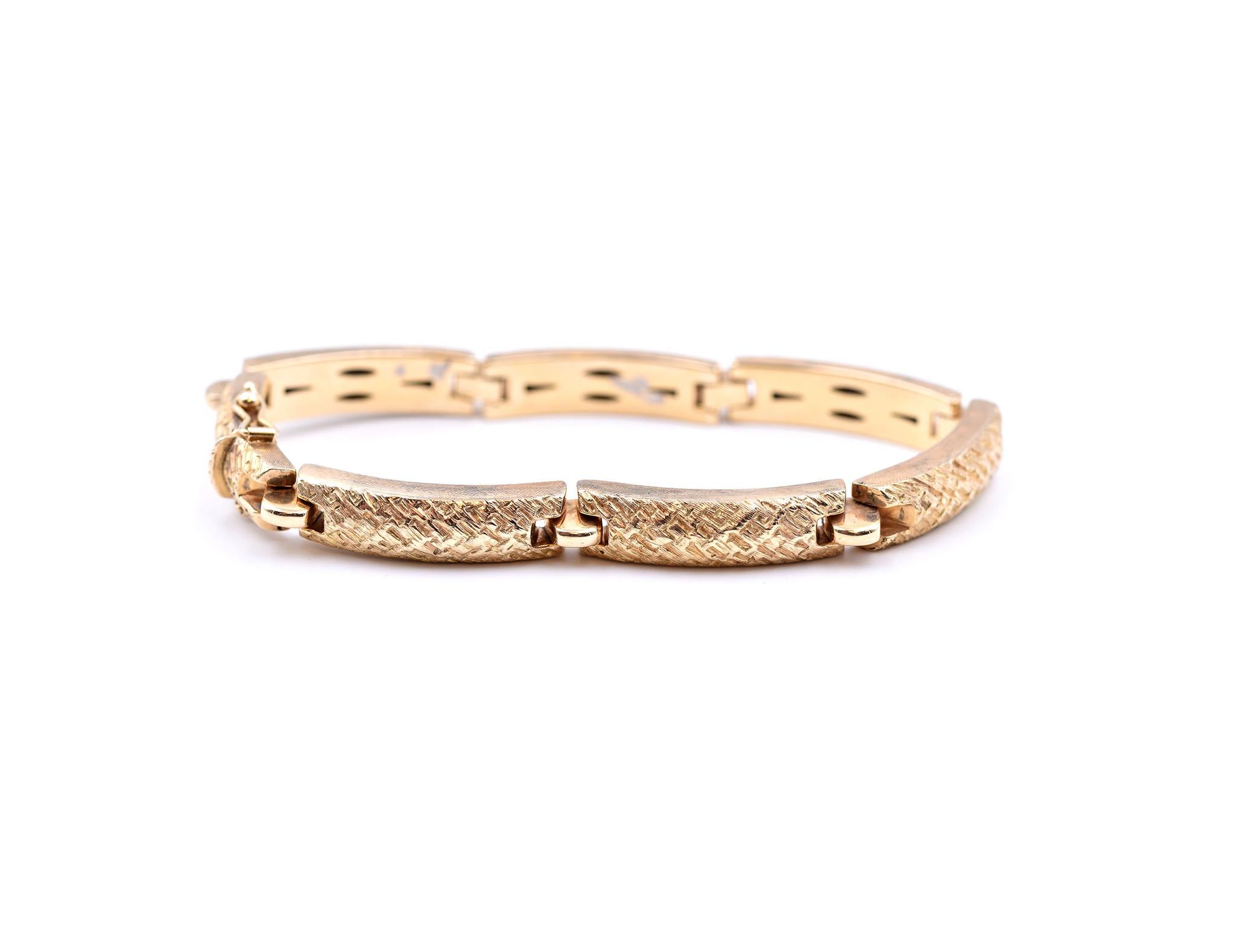 Designer: custom design
Material: 14k yellow gold
Dimensions: bracelet is 7 1/2-inch long x 3/8-inch wide
Weight: 12.3 grams
