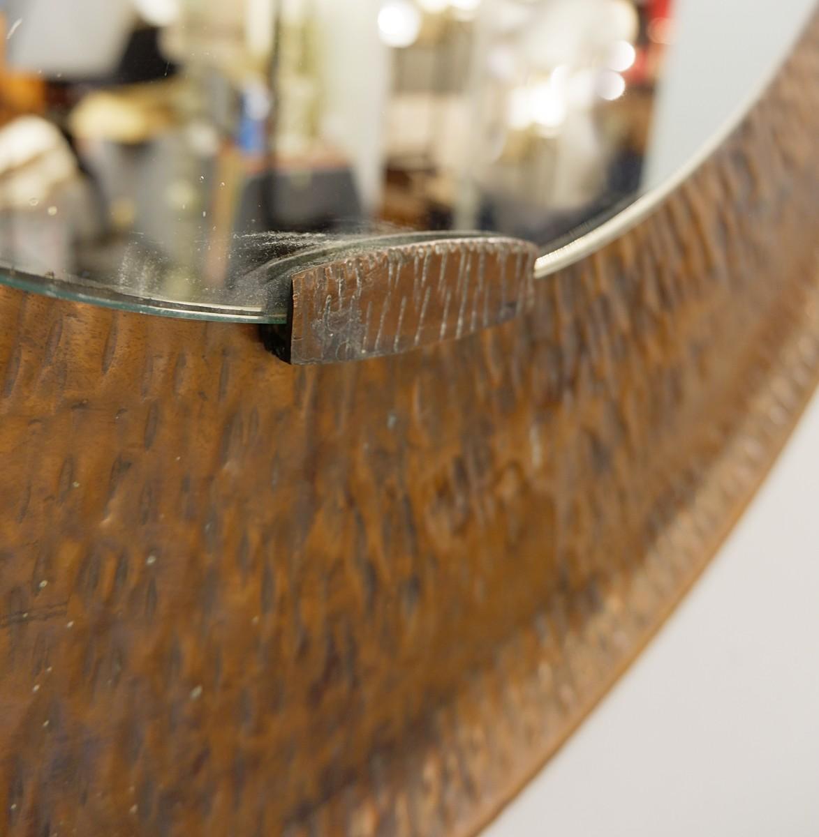 Hammered round copper mirror.