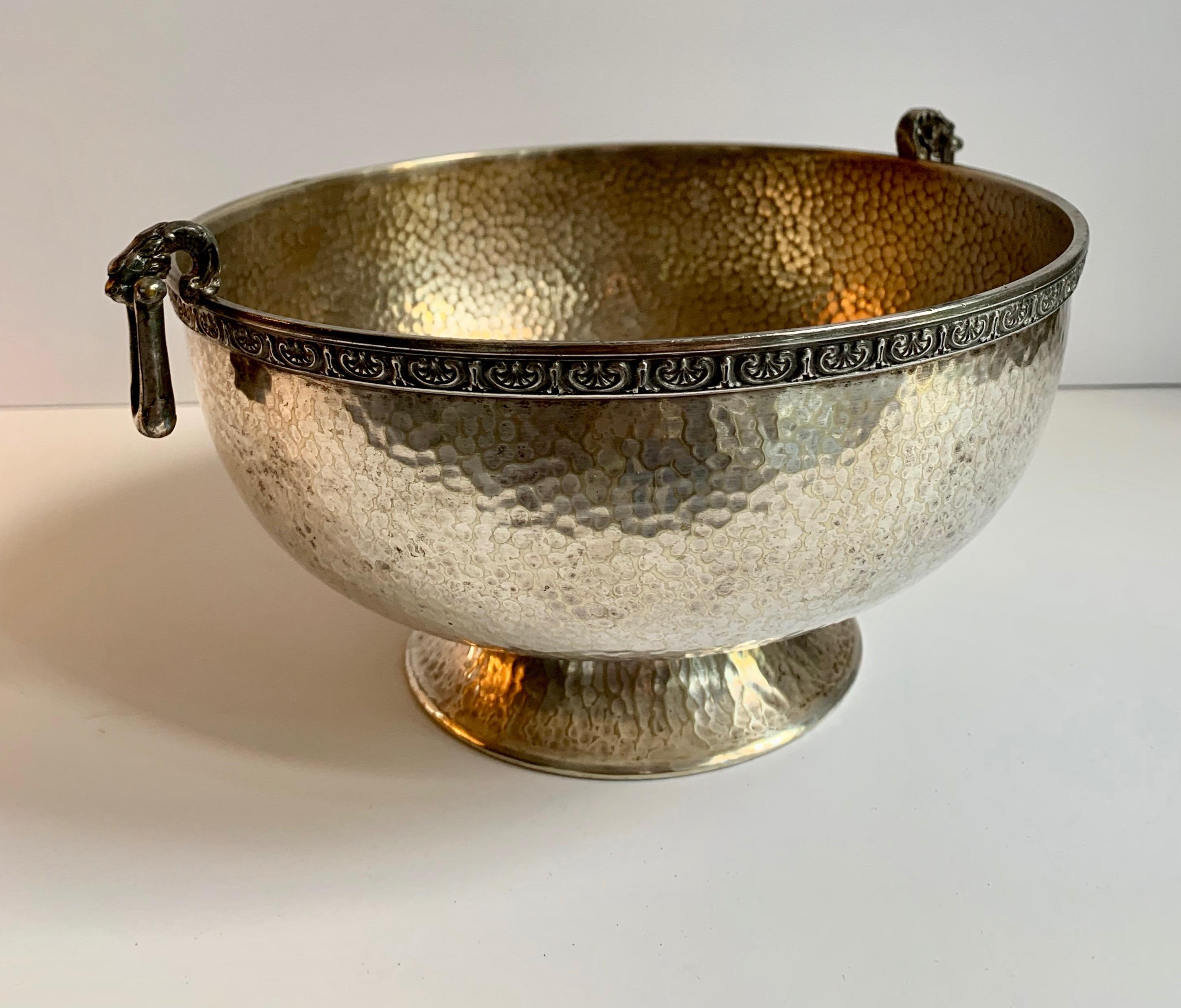 Hammered silver bowl with handle and rim detailing, a wonderful decorative bowl with great practical appeal. The rim is a fabulous detailed scroll reminiscent of a Greek key, with dangling rectangular detailing, similar to wonderful earrings.