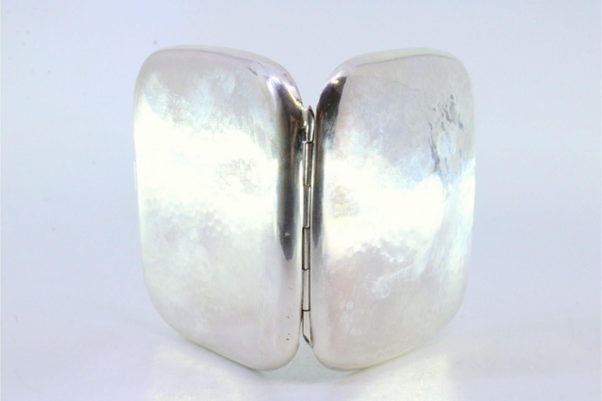 European Hammered silver cigarette case with hinged lid and two ribbons inside For Sale