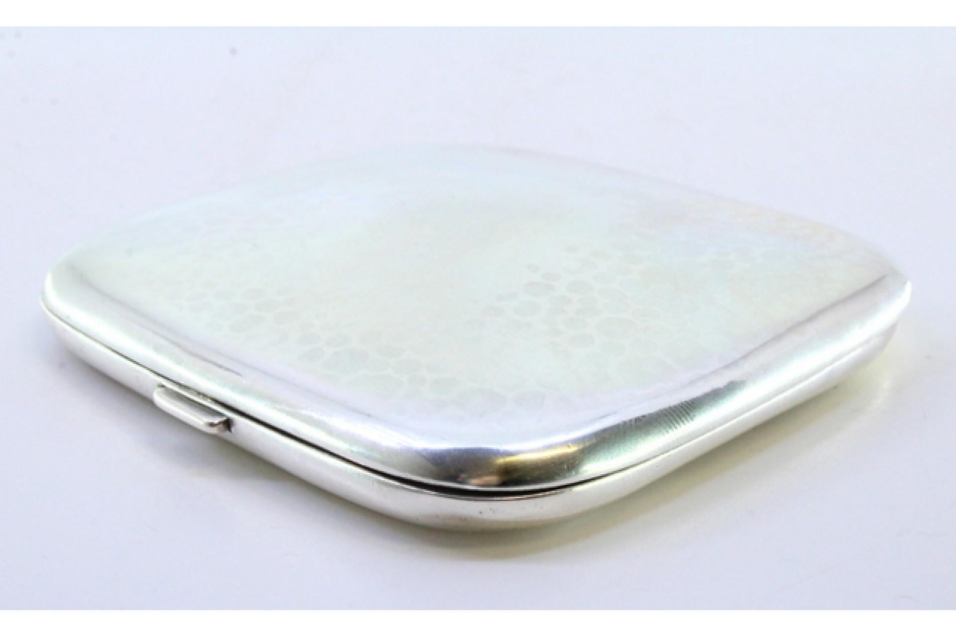 Silver Hammered silver cigarette case with hinged lid and two ribbons inside For Sale