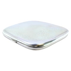 Hammered silver cigarette case with hinged lid and two ribbons inside