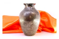 Hammered silver pot with reliefs and applications on the rim