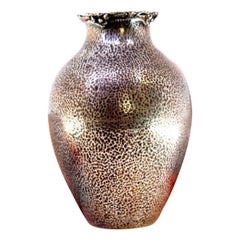 Hammered silver pot with reliefs and applications on the rim