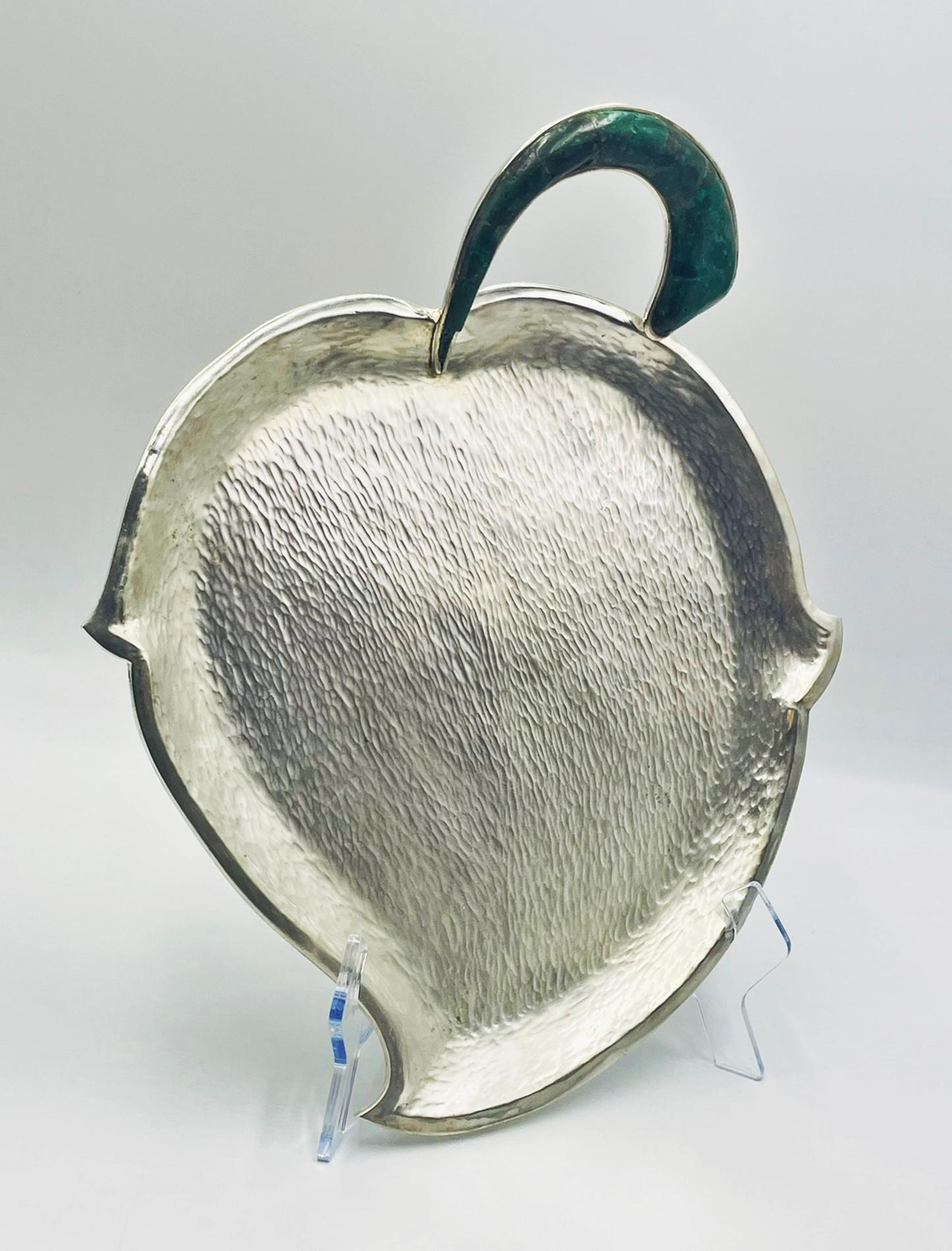 A sculptural 1950s hammered silver-plate serving tray designed and handcrafted by the renowned Los Castillo workshop in Taxco, Mexico, one of the most influential silversmithing ateliers of the 20th century. The tray features a beautifully contoured