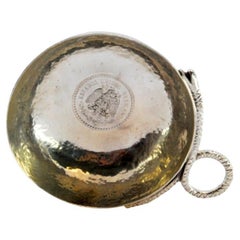Hammered silver wine taster cup with snake handle 
coin center