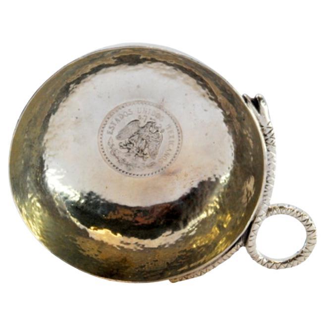 Hammered silver wine taster cup with snake handle 
coin center