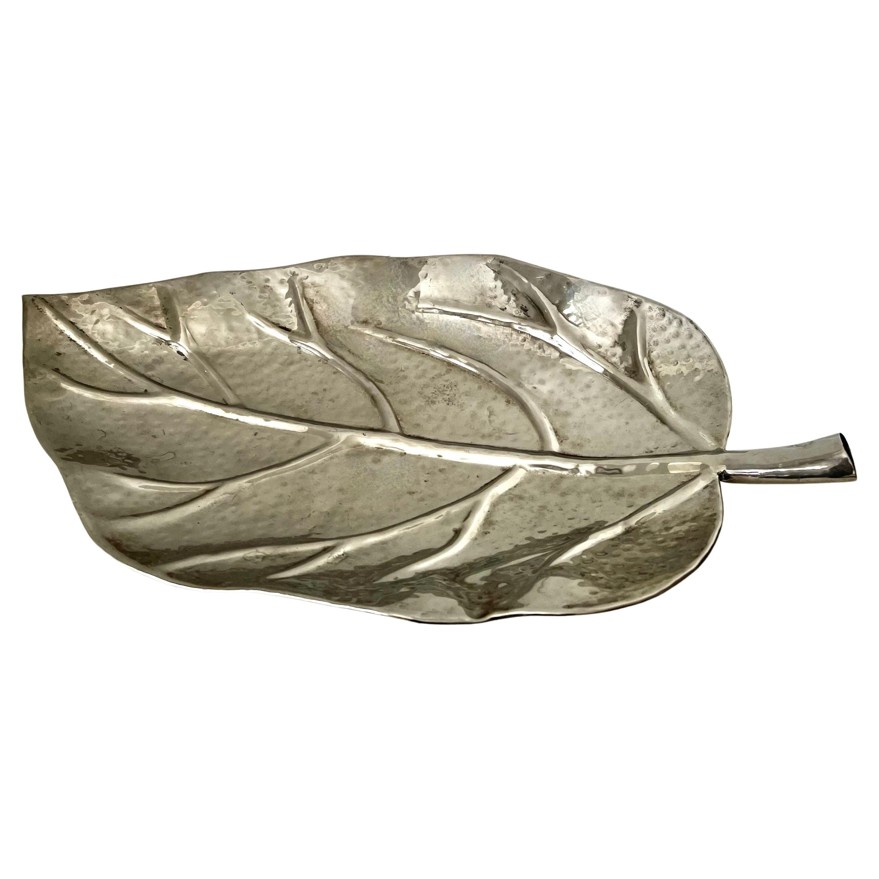 a Wonderful Large Leaf shaped serving tray or decorative piece.  The silver is hammered and when polished is stunning, but also looks great with a bit of patina.

A compliment to any cocktail table, as a decorative piece in any room or kitchen. 