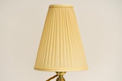 Hammered table lamp with glass stem and fabric shade around 1920s