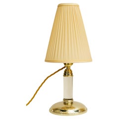 Hammered table lamp with glass stem and fabric shade around 1920s