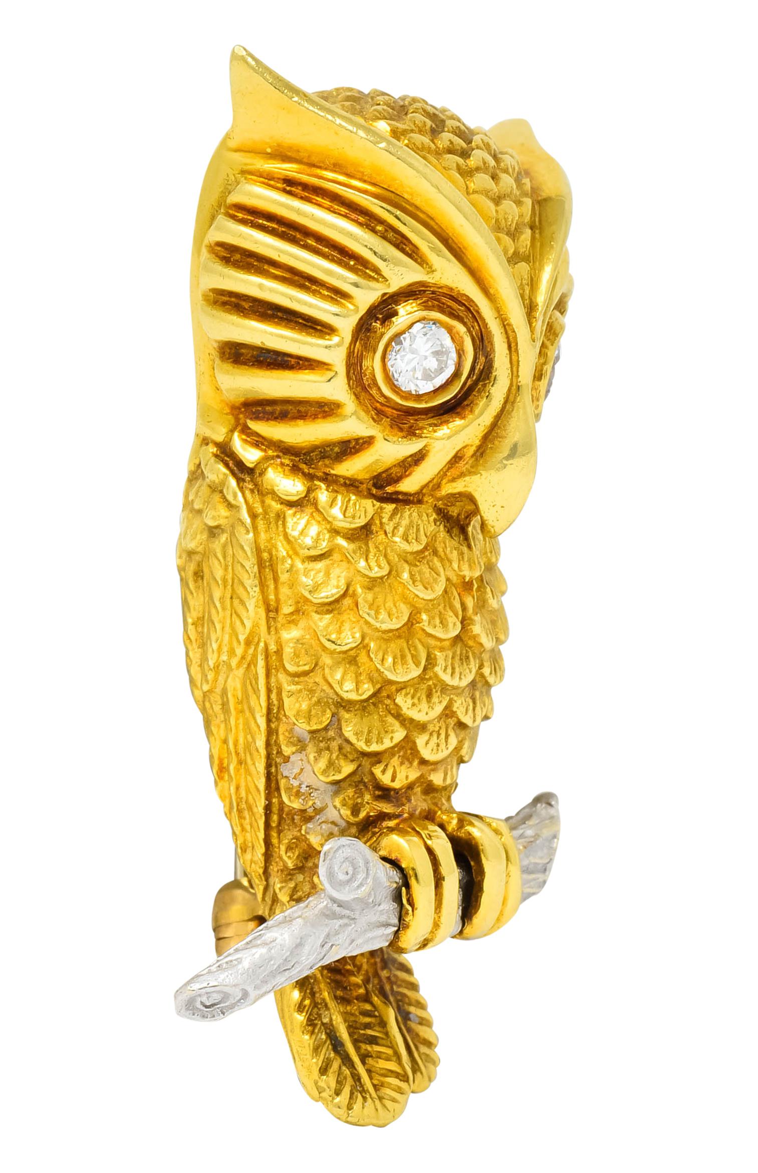 Brooch designed as a gold owl perched on a platinum branch with highly rendered feathers and detailed bark

Eyes are bezel set by two round brilliant cut diamonds weighing approximately 0.24 carat; G color and VS clarity

Completed by 14 karat gold