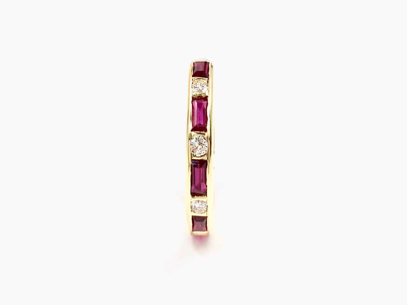 Timeless 18 karat yellow gold 3mm wedding band or stacking ring featuring alternating channel set horizontal baguette cut rubies and round brilliant diamonds. Vivid, well saturated rubies have a total weight of 1.17 carats. Round brilliant diamonds