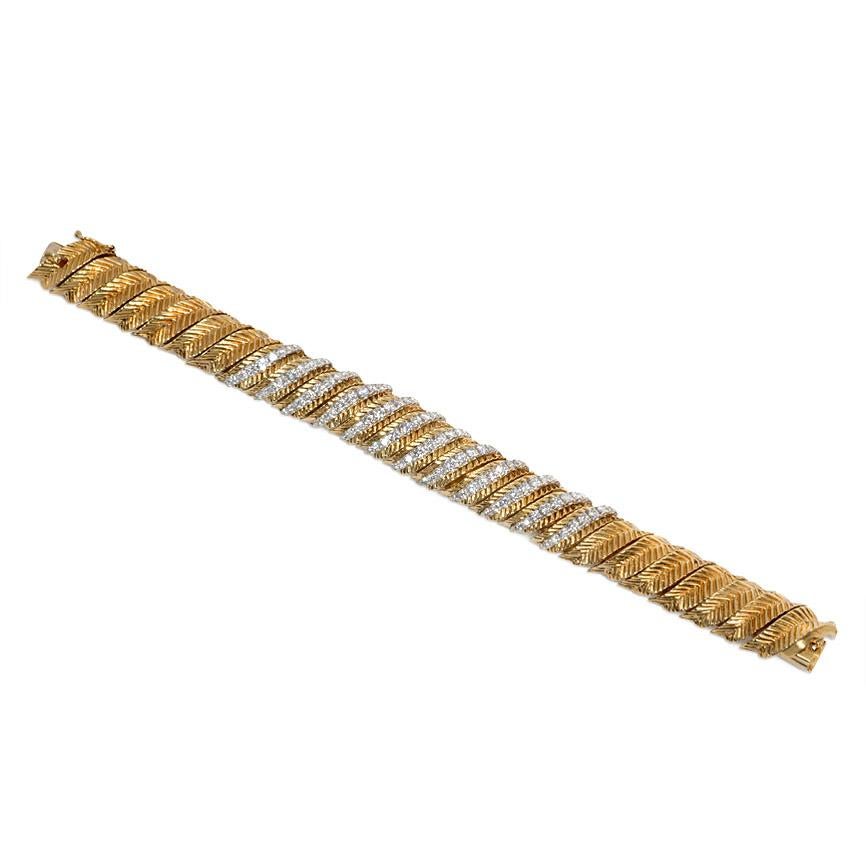 A gold and diamond bracelet comprised of diagonal articulated and incised gold sections with diamond ribs, in 18k and platinum.  Hammerman Brothers.  Atw. 4.00 ct diamonds.

Hammerman Brothers are an American manufacturing and design firm that has