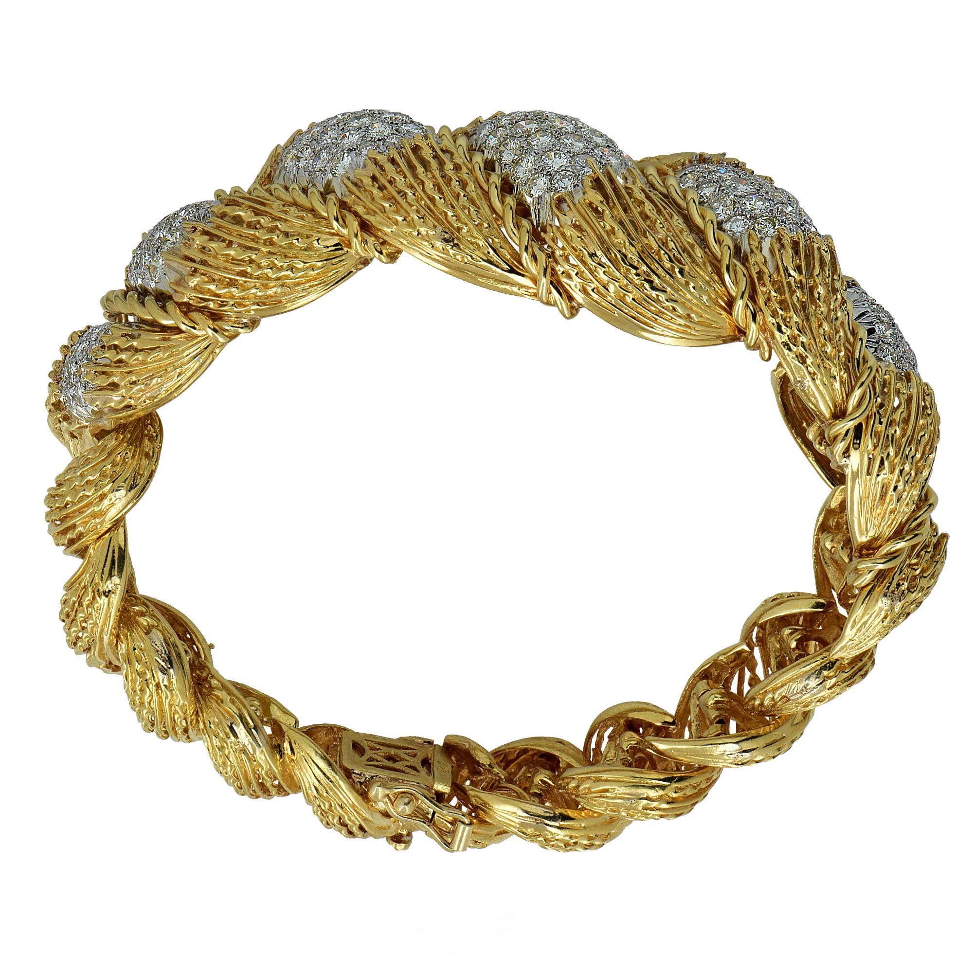 Gorgeous 18k yellow gold and platinum Hammerman Brothers bracelet featuring 147 round brilliant cut diamonds weighing approximately 6.5cts total H color Vs clarity. This finely crafted bracelet is rich in texture and enveloping layers, with twists