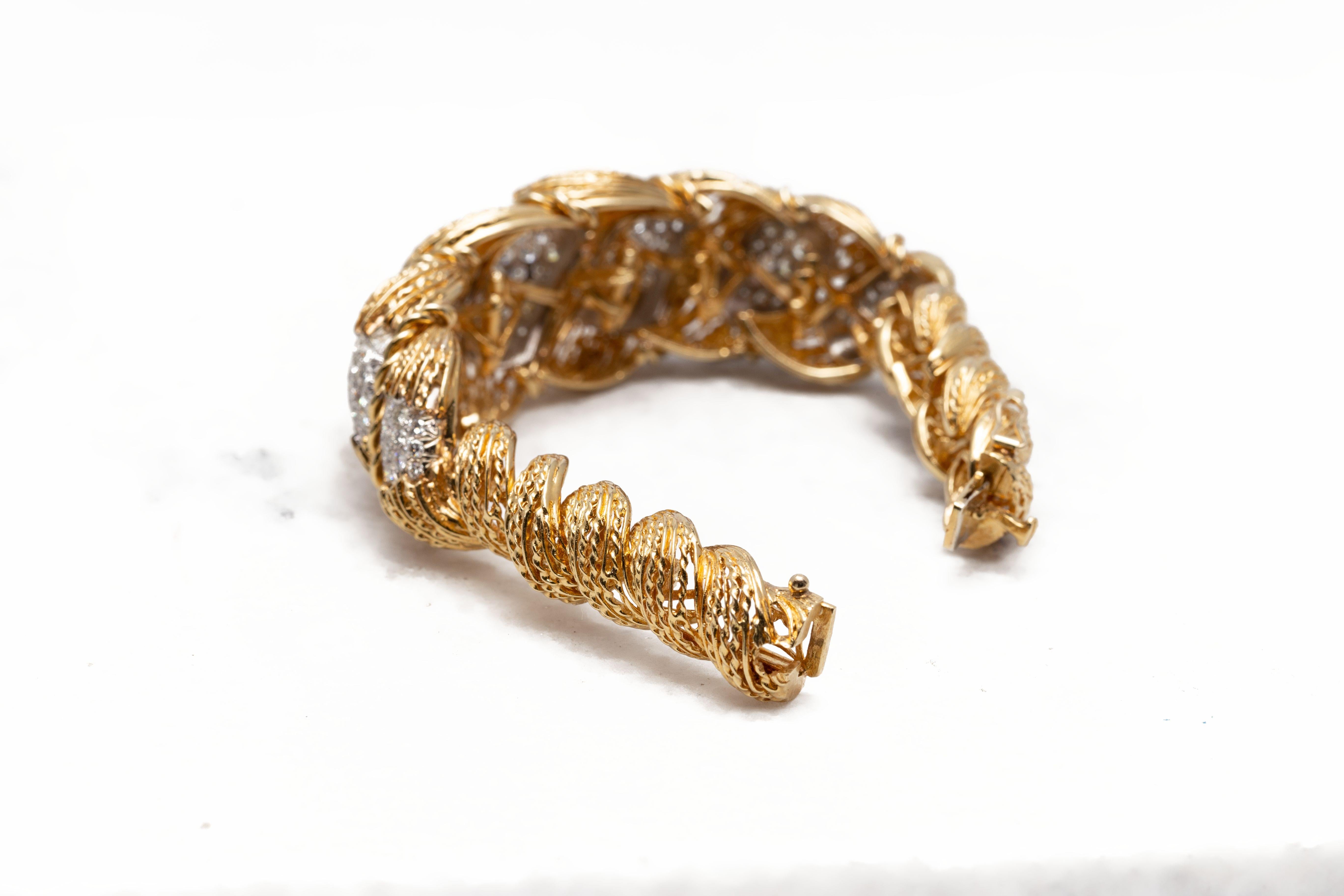 Signed Hammerman Brothers 1970s semi flexible cuff bracelet crafted in 18K yellow gold, adorned with sparkling Diamonds weighing approximately 6.50 carats. Signed Hammerman Brothers, this stylish bracelet is fitted with a tab insert. With its