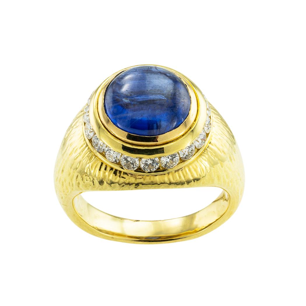Hammerman Brothers cabochon sapphire and diamond yellow gold ring. *

ABOUT THIS ITEM:  #R-DJ21D. Scroll down for detailed specifications.  The cabochon sapphire is encircled by a course of channel-set diamonds making it a truly elegant ring with