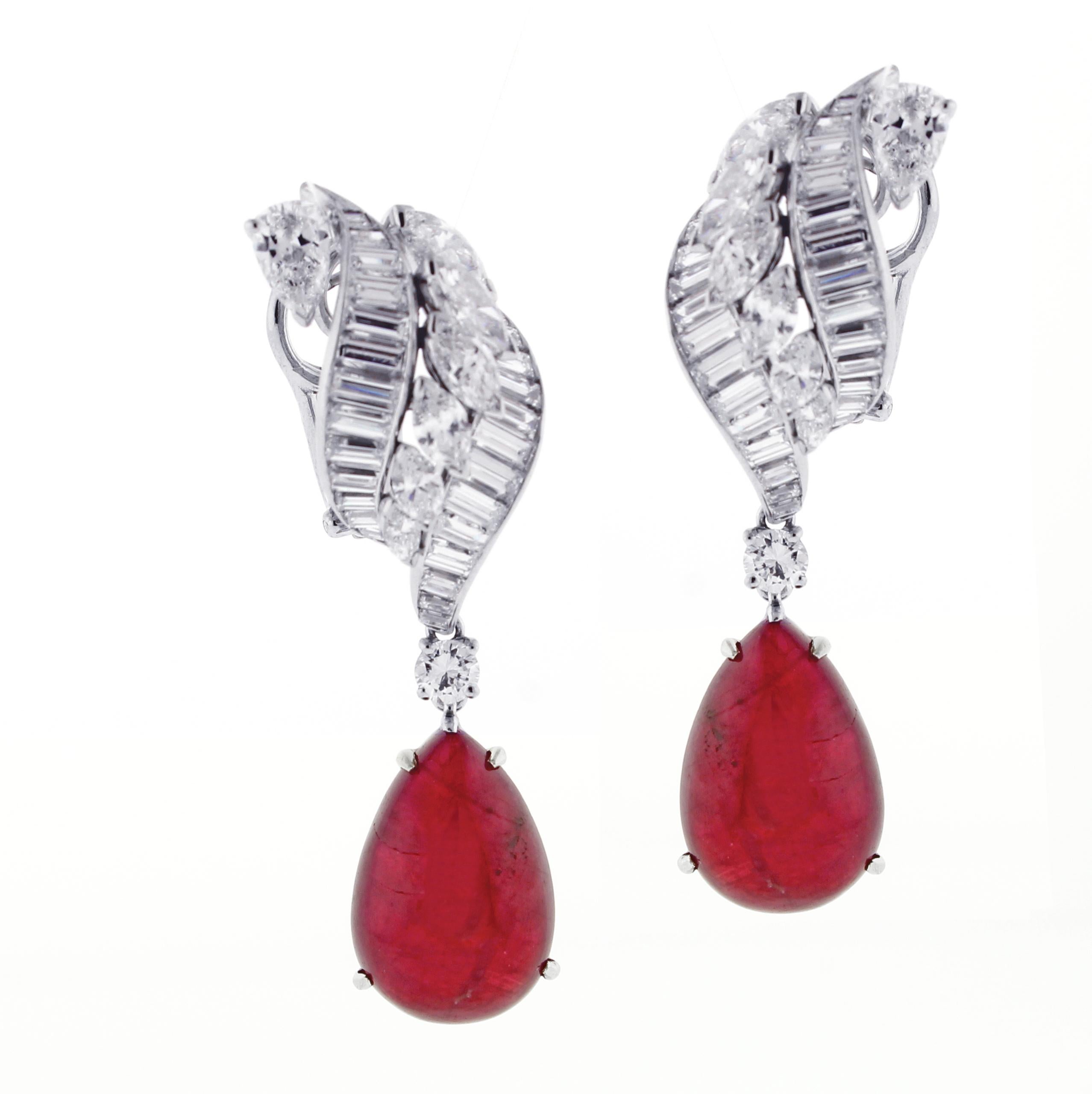 From Hammerman Brothers,  a pair of pear shape cabochon ruby and diamond drop earrings.
♦ Designer:  Hammerman Brothers 
♦ Metal: Platinum with 18kt white gold clips
♦ 2 cabochon rubies 20 carats
♦ 52 Baguette diamonds=2.50, 12 Marquise diamonds=2