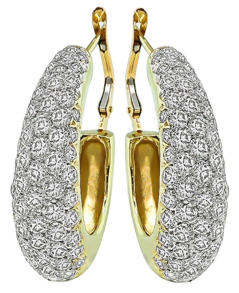 This elegant pair of 14k yellow and white gold earrings by Hammerman Brothers. The earrings feature sparkling round cut diamonds that weigh approximately 5.50ct. graded F-G color with VS clarity. The earrings measure 30mm by 9mm and weigh 15.5