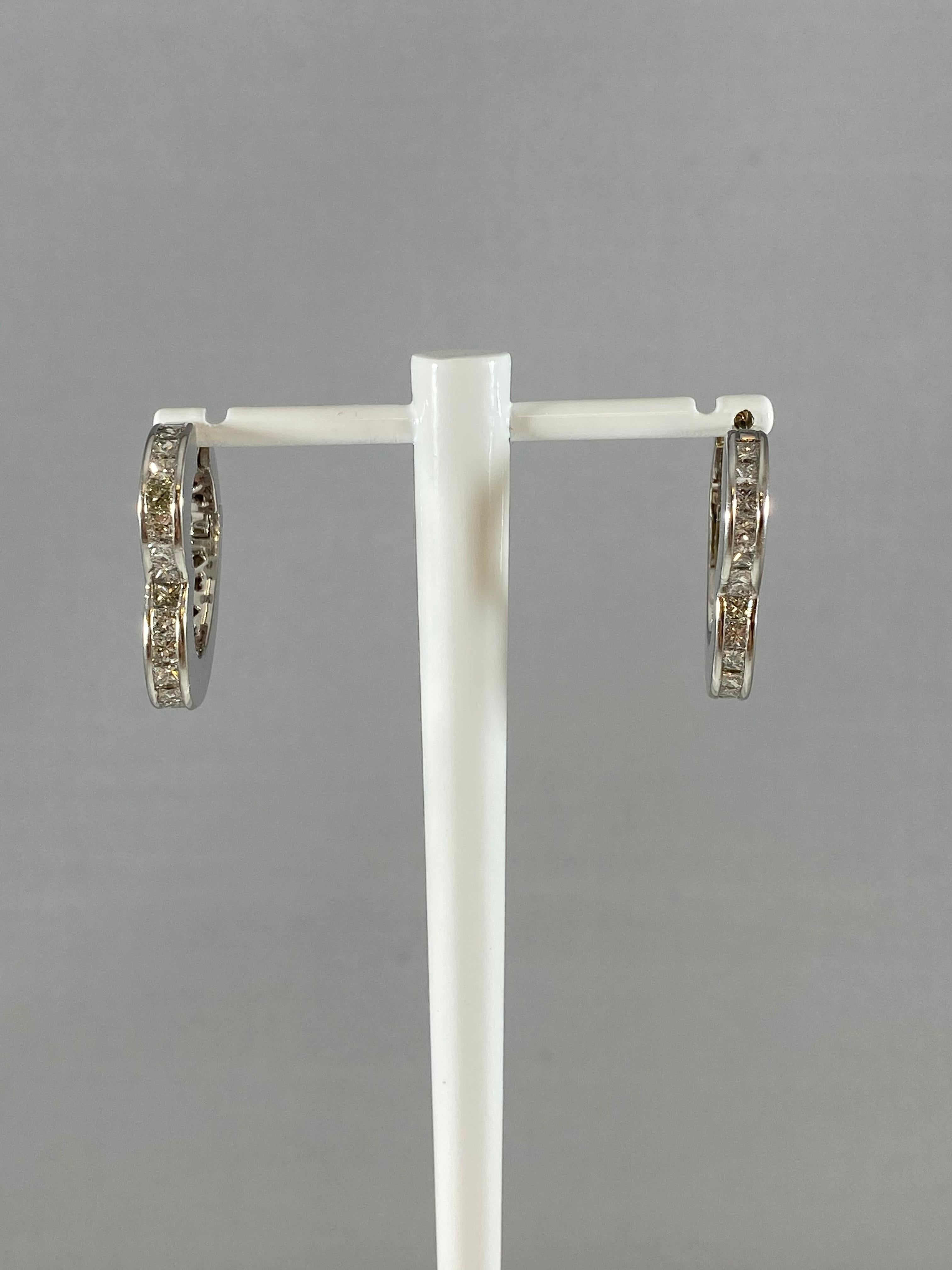 Heart hoops never go out of style. Hammerman Brothers platinum heart hoops with white princess cut diamonds. 28 diamonds, totaling 1.99 carats. 