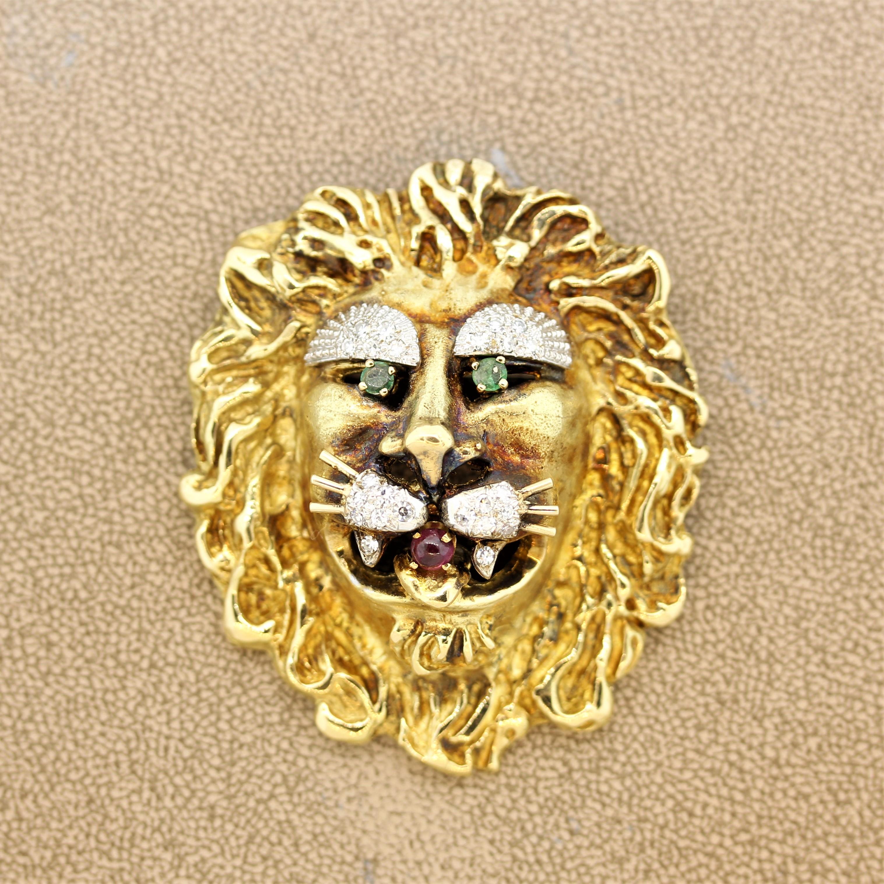 A classic whimsical brooch by Hammerman. The brooch is hand sculpted in 18k yellow gold in the form of a mighty yet sweet lion. It has emerald eyes along with a cabochon ruby mouth and diamond eyebrows and whiskers. The lion’s mane is beautifully