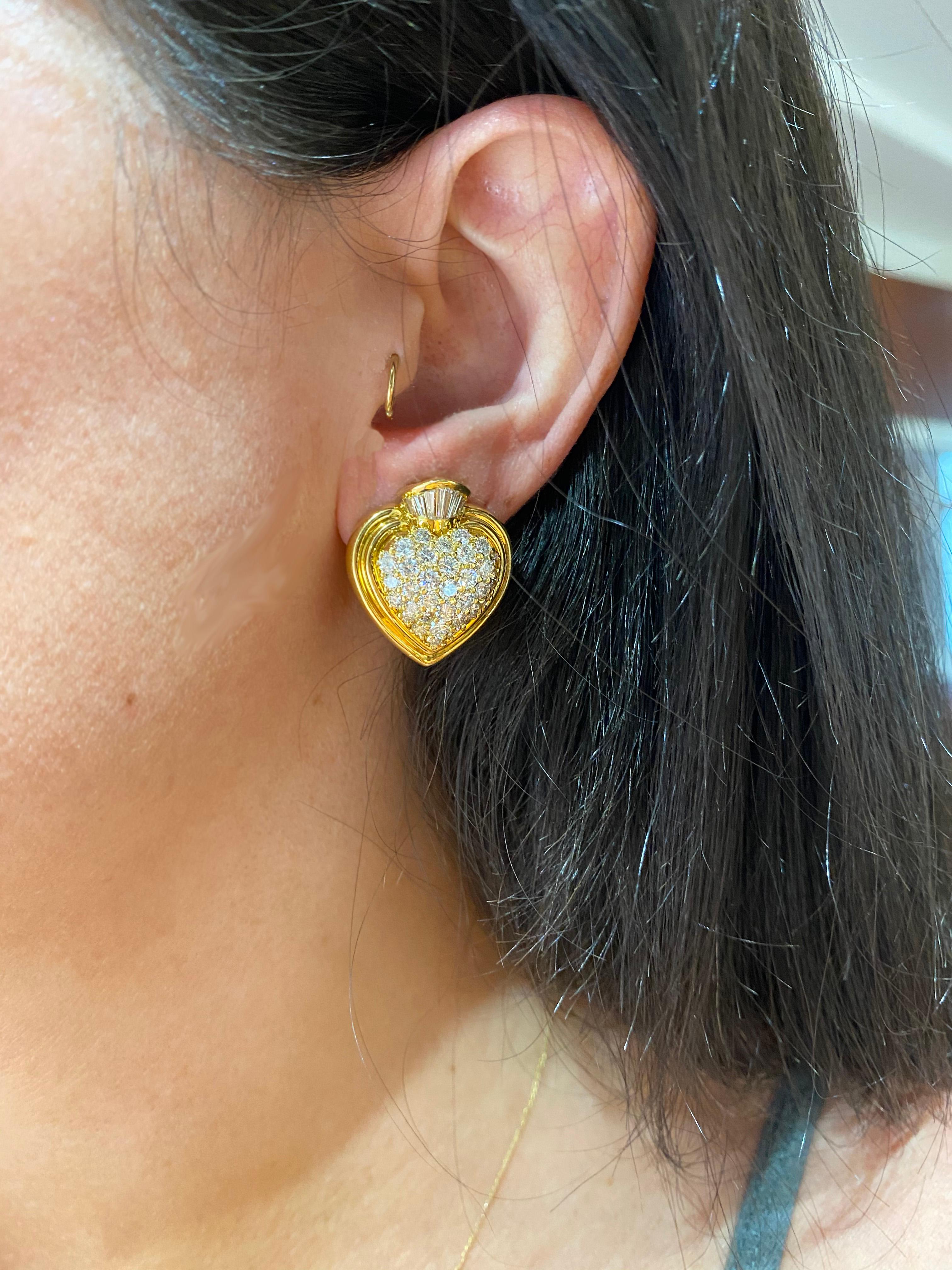 Statement earrings are not for the faint of heart. Pair with jeans and a tee or your favorite Sacred Heart D&G couture. Hammerman Brothers 18 karat yellow gold diamond heart earrings with pave round diamonds and a custom baguette diamond crown. 68