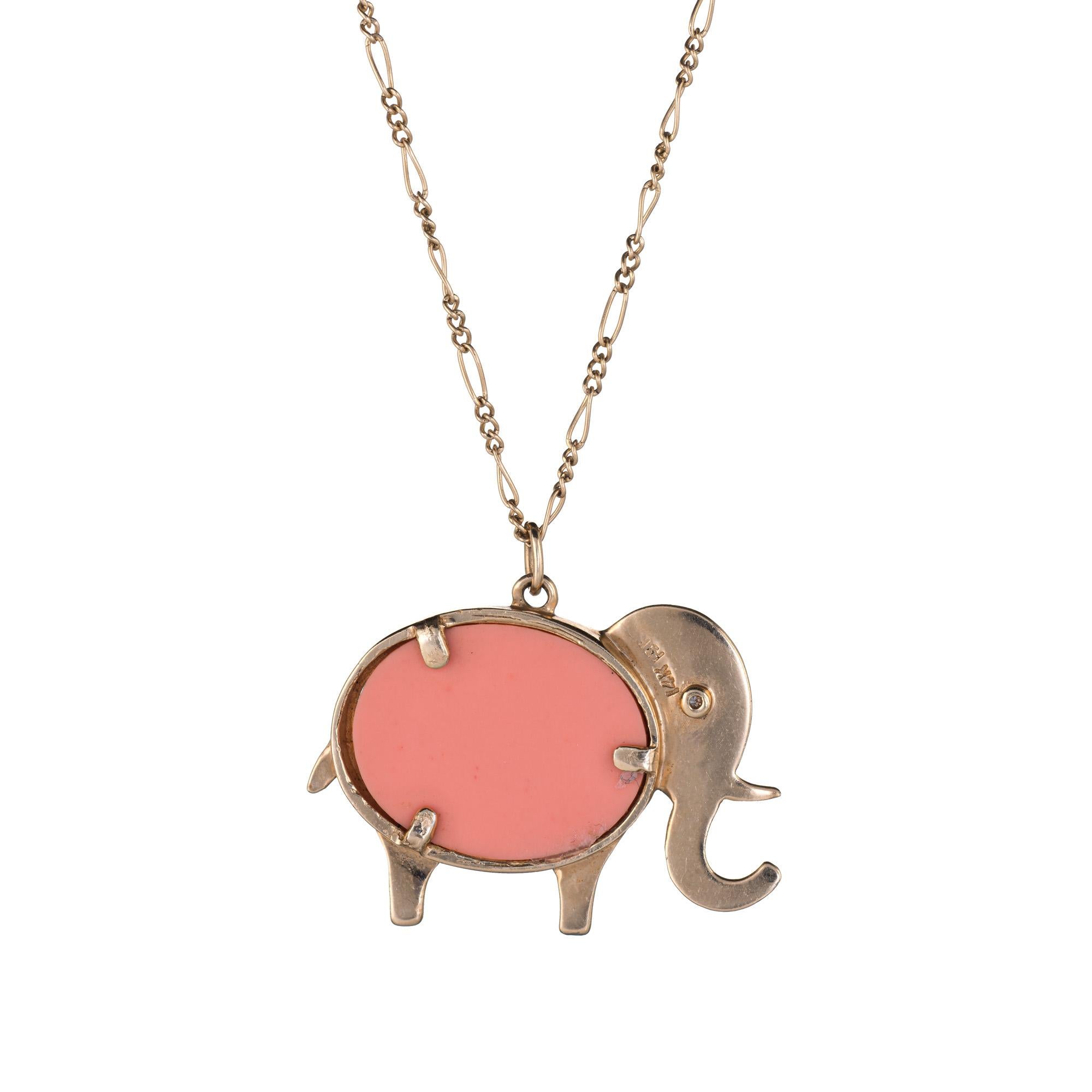 Finely detailed vintage Hammerman Bros elephant pendant crafted in 14 karat yellow gold.  

The elephant is set with composite coral in the body and a small estimated 0.01 carat diamond in the eye (estimated at G-H color and VS2 clarity).   

The