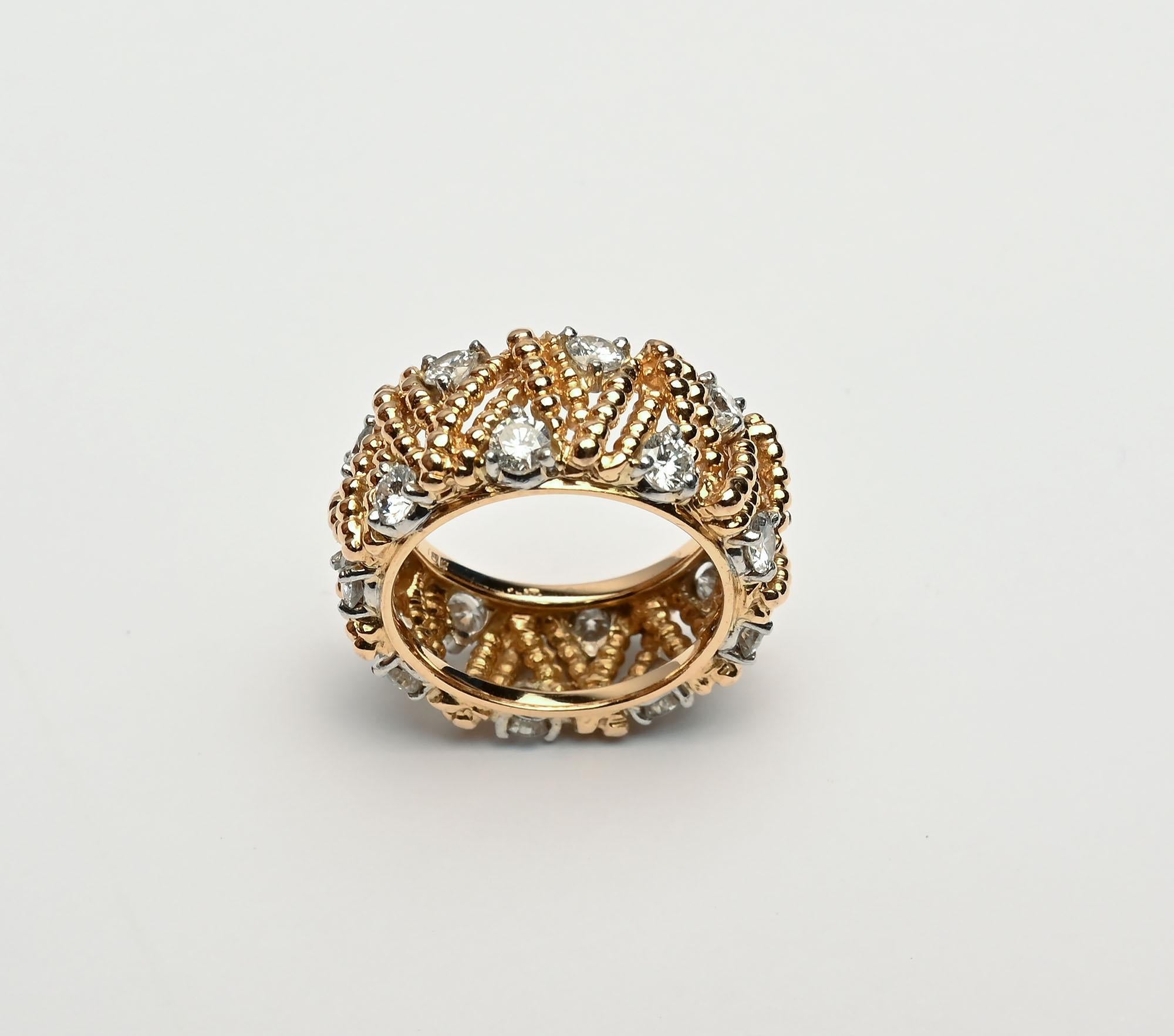 Stunning gold and diamond band ring by Hammerman Brothers. The ring has a lovely V shaped design with a diamond in each open space. There are  18 diamonds with a total weight of 1.8 carats. The ring is size 6 .5 and unfortunately, it cannot be