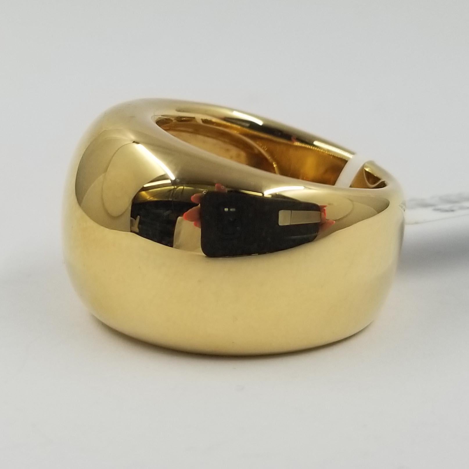 This simple ring is crafted in 18 karat yellow gold from designer Hammerman Brothers. It's heavy design is a high polish plain dome that tapers from 16mm wide at the top to 10mm at the back. Current finger size is 7.5; purchase includes one sizing
