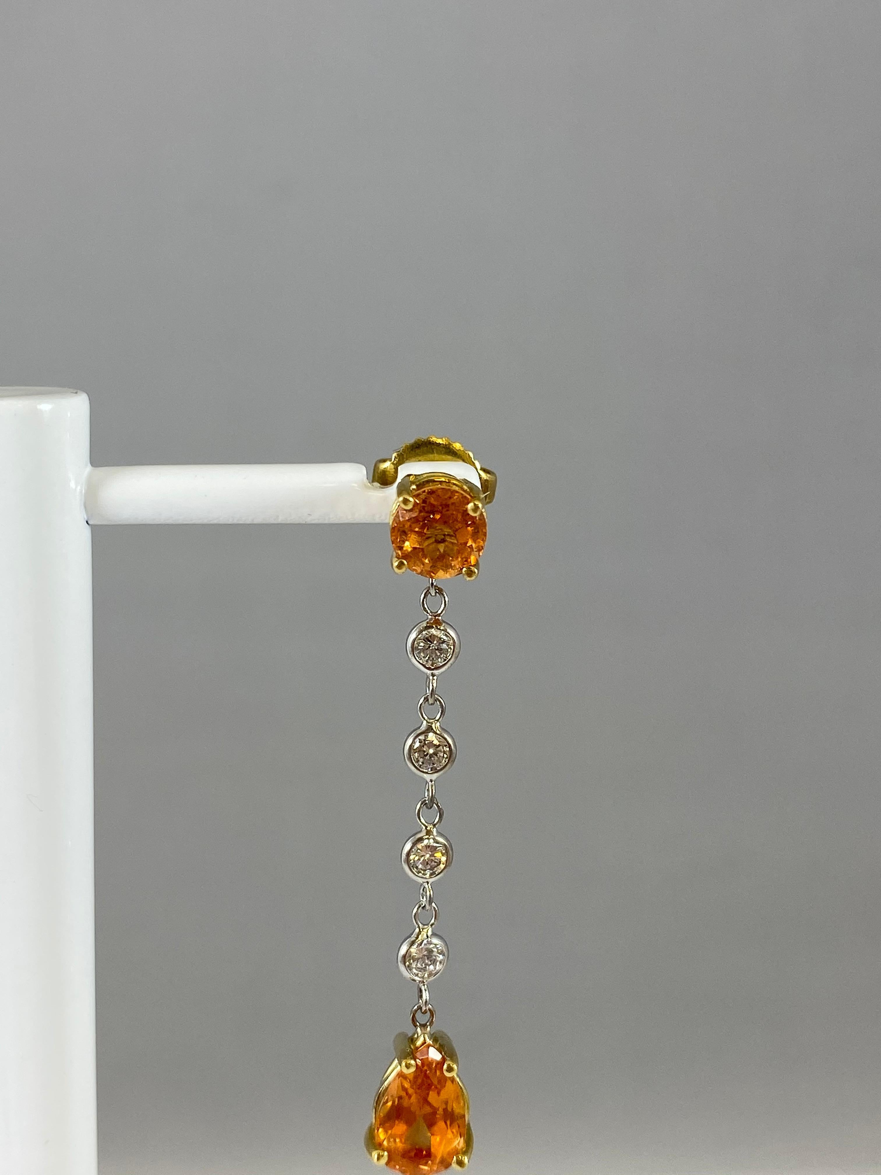 Hammerman Jewels 18 Karat Yellow Gold Mandarin Garnet and Diamond Dangle Earrings. 0.52 carats of diamonds, and 4.04 carats of mandarin garnet. 