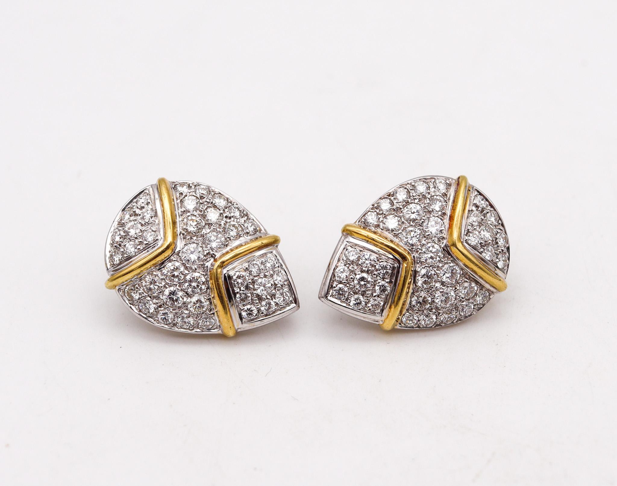 Modernist earrings designed by the Hammerman Brothers.

Gorgeous modernist pair of earrings, created by the Hammerman brothers. These pair has been crafted with a pear shape in solid white gold of 18 karats with accents of yellow gold. Fitted with