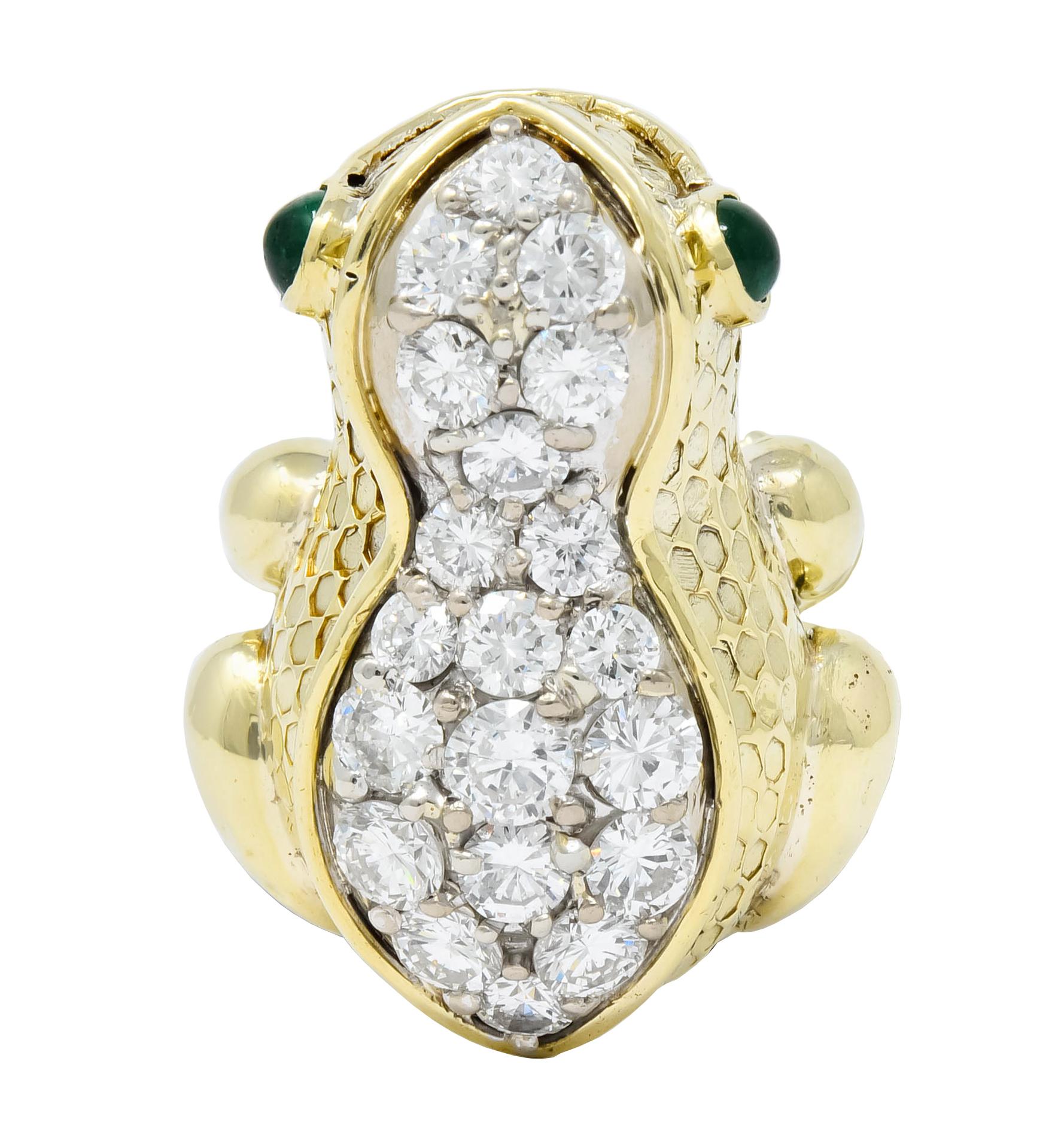 Ring designed as a perched, smiling frog featuring round emerald cabochon eyes and a deeply textured scale-like finish

With a pavé field back set throughout with round brilliant cut diamonds weighing approximately 2.75 carats total, G/H color and