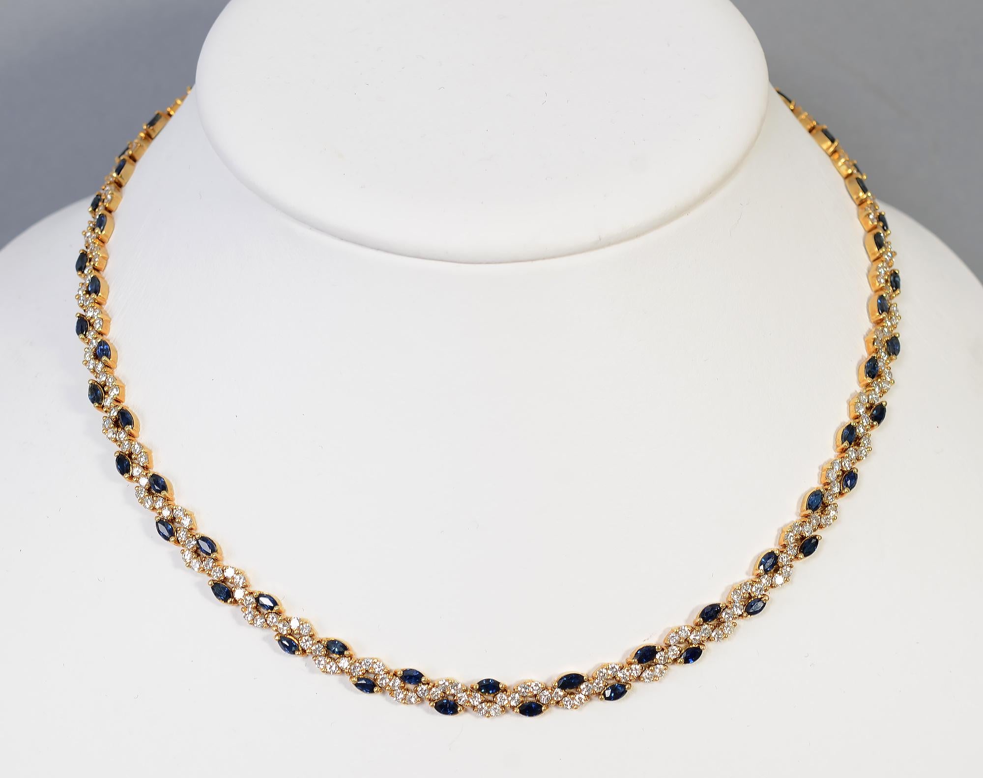 Elegant choker necklace by Hammerman Brothers with a design of undulating diamonds alternating with sapphires.
The necklace has a total weight of approximately 6 carats of diamonds that are SI quality and G color. Sixty six sapphires weigh