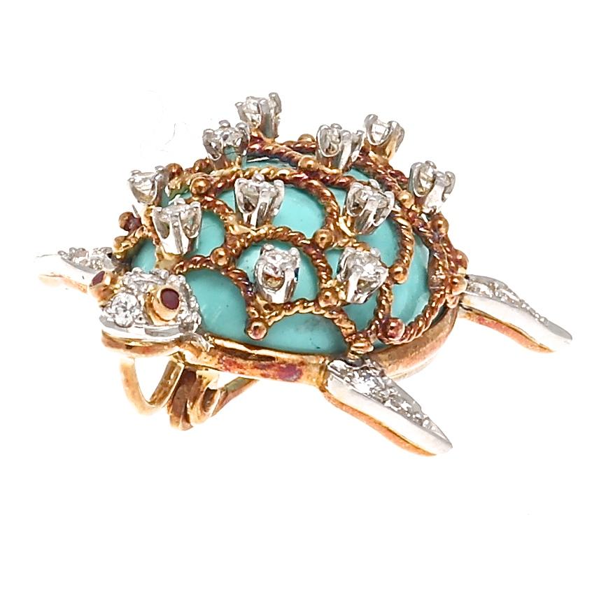 A glimpse of life in the deep blue sea. Decorated with turquoise, diamonds and rubies and the motif being captured in 18k gold and platinum. Signed Hammerman & Bros.