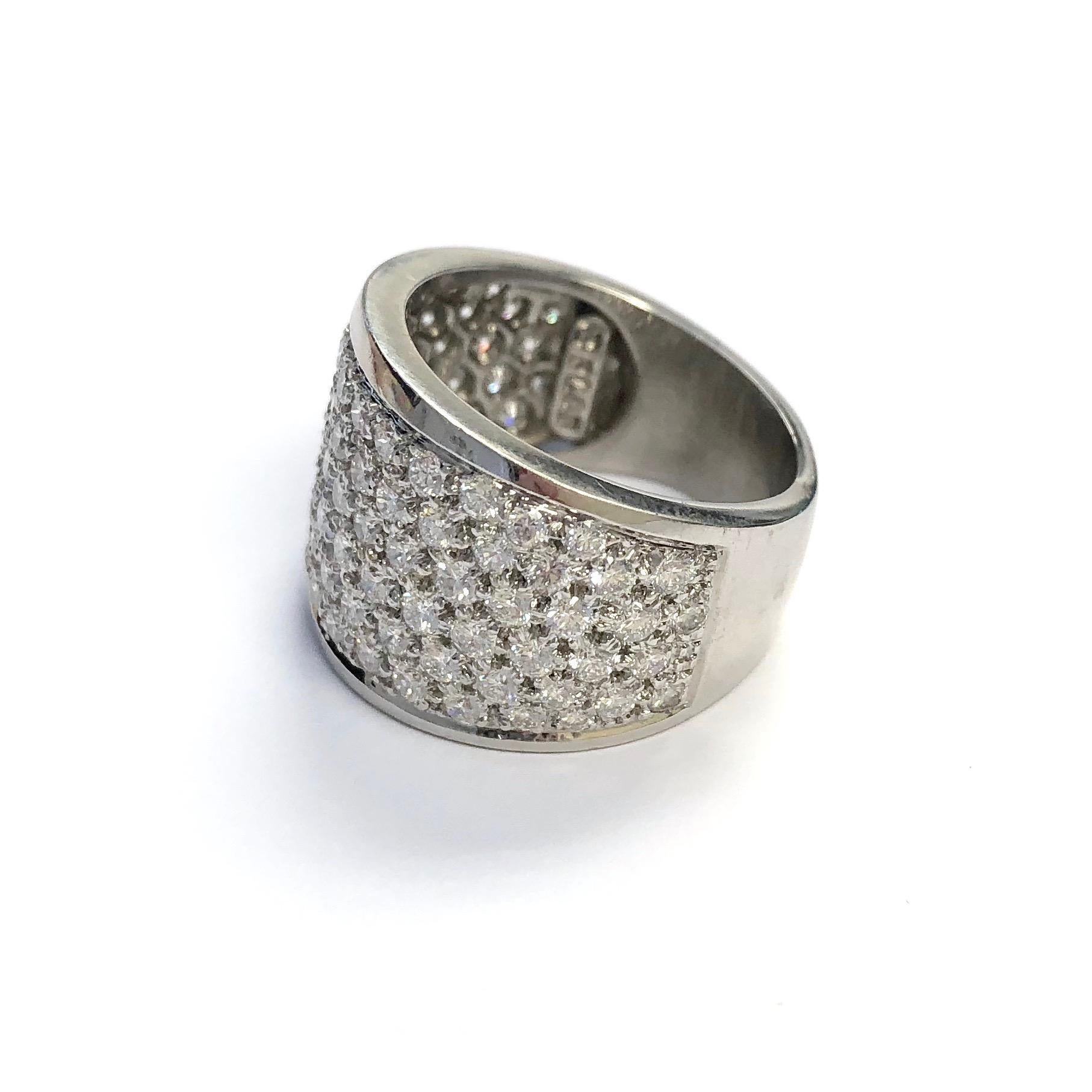 Magnificent platinum diamond band from the famous jewelry house Hammerman Brothers. Featuring six rows of diamonds on the front tapering down to a seven minnimeter band on the back. 100 round brilliant cut diamonds, approximate total weight of