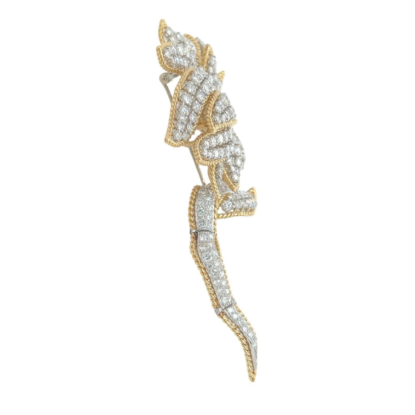 An 18 karat yellow gold, platinum and diamond brooch, Hammerman Brothers.  Designed as a flower, the petals, leaf and flexible stem outlined in gold ropework, enclosing approximately two hundred thirty seven platinum set round brilliant cut